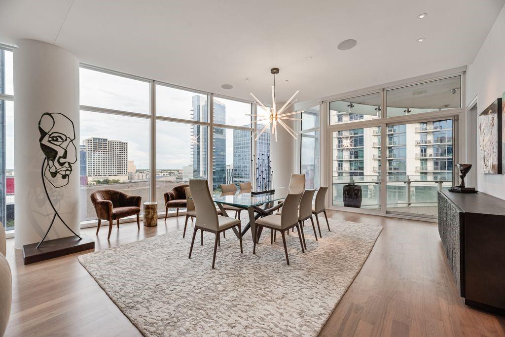 Perched on the 10th floor of Museum Tower, Residence #1002 offers sophisticated high-rise living in the heart of the Dallas Arts District. Spanning 2,407 square feet, this beautifully appointed two-bedroom, two-bath residence pairs exceptional design with a level of service rarely found in residential living. A private elevator opens directly into the residence, where floor-to-ceiling glass fills the home with natural light and frames expansive views across Dallas. The sleek contemporary kitchen features gray lacquer cabinetry, basalt countertops and Miele appliances, opening seamlessly to generous living and dining spaces. A mirrored dry bar with wine refrigeration adds another polished layer, while automated shades and integrated surround sound bring effortless comfort throughout the home. The living area flows to a private terrace, extending the residence outdoors with a beautiful vantage point over the city. The primary suite is a serene retreat with a luxurious marble-clad bath, dual vanities and generous closet, while the second bedroom offers privacy and flexibility for guests. Beyond the residence, Museum Tower delivers an extraordinary level of service. Valet attendants are at the ready upon arrival, while an attentive front desk and concierge team remain remarkably in tune with the needs of residents. From pet services and resident assistance to countless details handled behind the scenes, life at Museum Tower is designed to feel seamless. Residents enjoy a resort-style pool and spa, state-of-the-art fitness center, full locker rooms with sauna, sophisticated resident lounges, guest accommodations and an extensive collection of personalized services. Located in the Dallas Arts District, moments from Klyde Warren Park, acclaimed museums, dining and entertainment, Residence #1002 offers a rare combination of sophisticated design, privacy and exceptional service. Here, luxury is not simply found in the finishes, but in how effortlessly you are cared for.