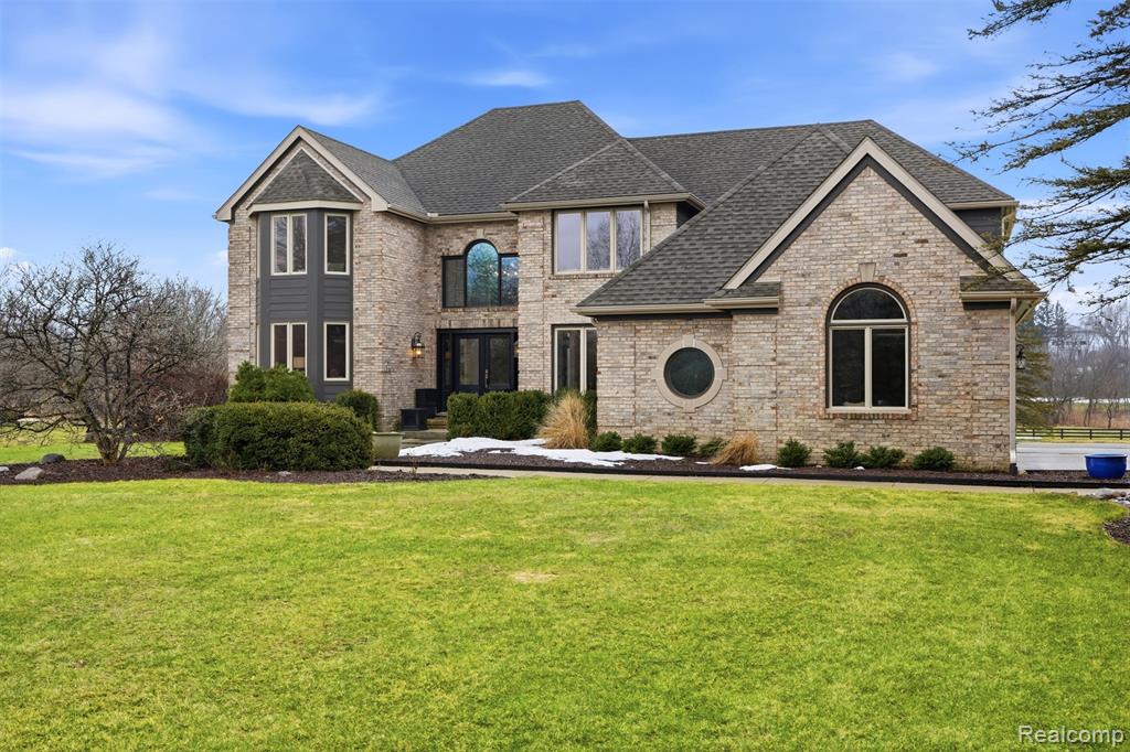 Stunning, light-filled 4 bdrm, 3.5-bath custom estate with 3-car garage, finished south-facing walkout bsmt, set on a breathtaking 16-acre private retreat with easement access to Atlas Park. This one-of-a-kind property blends luxury living with serene natural beauty, offering expansive views in every direction. The grounds are truly exceptional— a fruit orchard with peach, pear, plum, apple, cherry trees, grape vines, a large pond with fountain, charming greenhouse with tiled floors. Enjoy peaceful mornings and unforgettable sunsets surrounded by nature. Thoughtfully curated finishes and architectural details elevate every space. Highlights; wainscoting, crown molding, oversized base & case moldings, coffered wood ceiling in study, designer tile accents - baths & laundry. Owner’s suite is a private sanctuary with spa-inspired bath featuring soaking tub, tiled shower, multi-function shower heads, & coffee station. Kitchen showcases premium appliances; Sub-Zero frig, Bosch dw, gas Jenn Air down draft cooktop, Kenmore Elite dbl oven, all positioned to capture stunning backyard views Dramatic 2 story great rm centers around a striking stone wood-burning fireplace. Finished walkout offers in-law/guest suite,  kitchen (range, sink, frig and bar), full bath with tiled shower, spacious family rm with wood-burning fireplace, direct access to a large patio,hot tub and additional seating areas—perfect for entertaining. Built with quality and efficiency, exterior features; 2x6 walls, Hardie Plank siding, new windows throughout, newer electrical panel, expansive Trex deck with aluminum railing and retractable awning off the kitchen nook. Portable, Champion 15,000/12,000-Watt generator, capable of powering  essential house systems, with outside connection to the electrical panel, is included for added peace of mind. For those seeking privacy, luxury finishes, and unparalleled outdoor amenities this extraordinary estate offers a rare opportunity to own a truly distinctive property