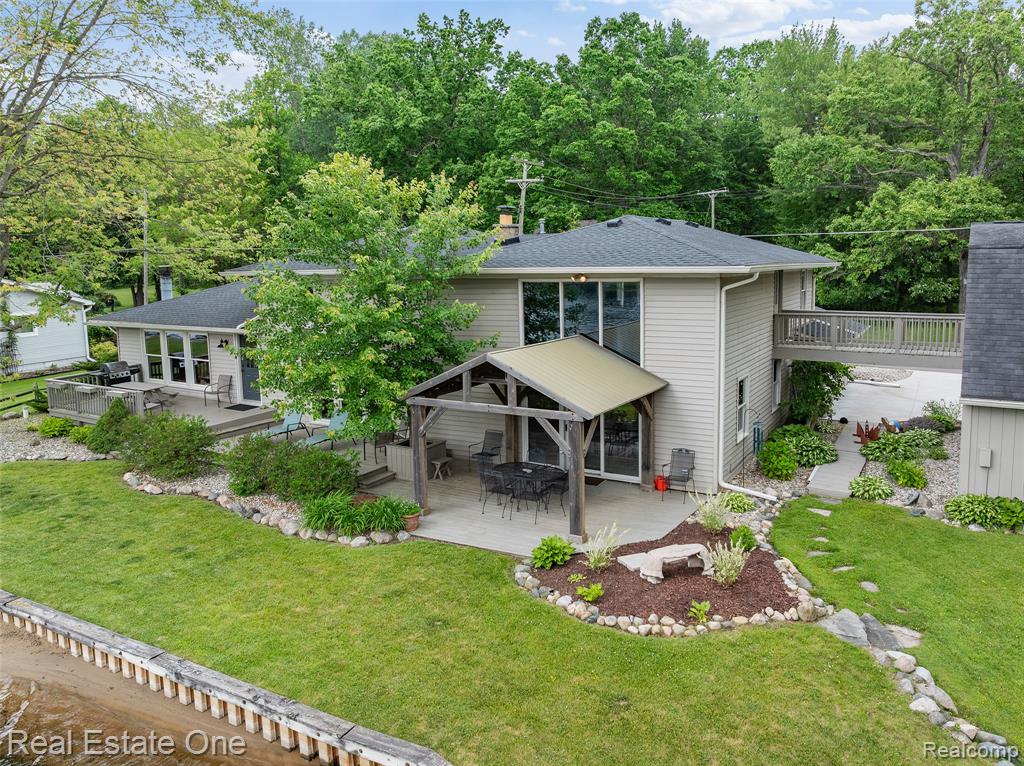 Welcome to Lake Life on All-Sports Strawberry Lake! This stunning 4-bedroom, 3-bath lakefront home offers 125 feet of private waterfront on one of Michigan’s desirable chains of lakes. With over 3,000 sq ft of living space, you’ll enjoy sweeping views, warm finishes, and comfortable spaces designed for both entertaining and relaxing. Step into the main living area with soaring ceilings, a wall of windows overlooking the lake, and a cozy loft above. The open-concept layout features a beautifully updated kitchen with custom cabinetry, island seating, fireplace and an expansive dining area that comfortably fits a crowd—all with panoramic water views. Cozy up in a spacious family room with a lodge-like feel, stone fireplace, media center, and easy access to the backyard and lake. Whether you’re enjoying coffee on spacious deck under the covered gazebo or sunset cruises on the water, this home is made for year-round enjoyment. Additional features include a large pole barn with space above ready to be finished for extra living quarters, a second lot across the street offering 2.30 acres of added privacy with unlimited potential. This is more than just a home—it’s a retreat. Whether it’s fishing, boating, or gathering with friends, Strawberry Lake living delivers a lifestyle you’ll treasure.