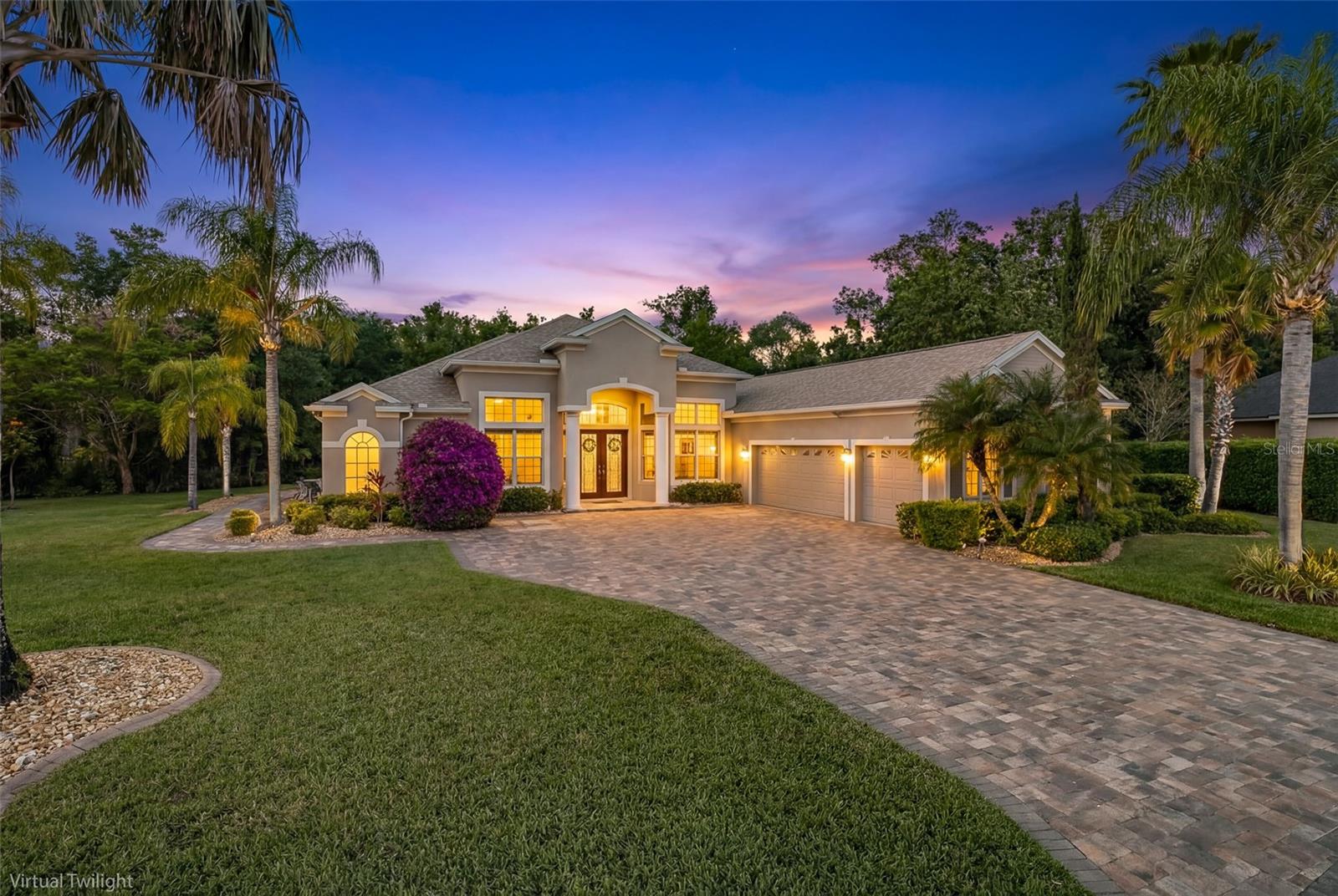 Nestled behind the coveted gates of Magnolia Estates, this magnificent 4 bedroom, 3 full bath, 1 half bath pool home with private office is perfectly positioned on a breathtaking 1/2 acre conservation homesite offering exceptional privacy and tranquil natural views. From the moment you arrive, the expansive driveway, lush tropical landscaping, and impressive curb appeal set the stage for what awaits inside this meticulously maintained residence. Designed with an open floor plan that lives large, this stunning home seamlessly blends elegance, comfort, and functionality. Soaring ceilings and beautiful tile flooring welcome you into the formal living and dining areas, creating the perfect backdrop for entertaining and everyday living alike. At the heart of the home, the chef-inspired kitchen is sure to impress with rich wood cabinetry, gleaming granite countertops, double ovens, cooktop, and abundant prep and storage space ideal for hosting gatherings both large and small.The spacious family room is warm and inviting, showcasing a custom-built entertainment wall complete with an electric fireplace, creating the perfect place to relax and unwind. Privately tucked away, the luxurious primary suite offers two closets and a spa-like en suite bath featuring dual vanities, a relaxing garden tub, and separate walk-in shower. Bedrooms 2 and 3 are generously sized with newer carpeting and share a well-appointed guest bath, while the 4th bedroom is ideally situated at the rear of the home with its own private bath that also serves as a convenient pool bath. A dedicated office, half bath and oversized laundry room complete this thoughtfully designed floor plan.Step outside to your own private Florida paradise. The sprawling screened lanai features a sparkling swimming pool with spillover spa, ample covered and open-air entertaining space, and peaceful conservation views with no rear neighbors. Whether enjoying sunny afternoons poolside or relaxing evenings under the stars, this outdoor retreat offers the ultimate in privacy and relaxation. This exceptional home has been lovingly maintained and extensively updated with valuable improvements including a BRAND NEW ROOF (2023), new pool pump (2024), upgraded pool enclosure and re-screening (2025), new water heater (2025), new primary HVAC system (2024), garage updates including paint, flooring, and custom cabinetry (2023), new carpet (2022), replaced window screens (2025), custom family room entertainment wall and surround sound system with lanai speakers (2020), freshly sealed driveway pavers (2026), and so much more. Residents of Magnolia Estates enjoy gated privacy along with community amenities including a playground and private boat launch ~ LOW HOA fees & NO CDD fees! Conveniently located in the highly desirable Trinity area just steps from Pinellas County, this home offers easy access to shopping, dining, top-rated schools, championship golf, beautiful Gulf beaches, and is just a short drive to Tampa International Airport and St. Pete–Clearwater International Airport.