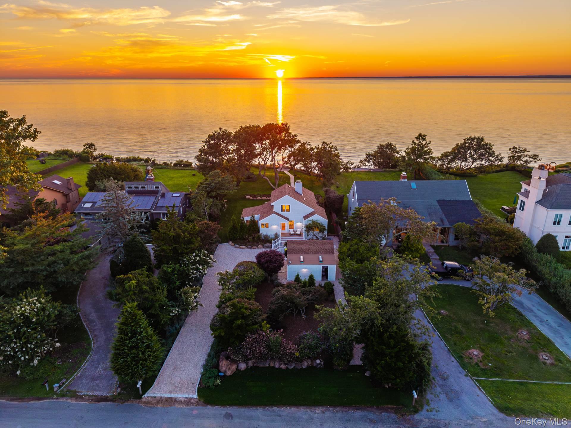 There are houses with water views, and then there are houses where the water is the whole point. Located in a waterfront beach community with tennis and pickleball, 380 The Strand delivers the rare North Fork combination of waterfront, an elegant renovation, community amenities, and a setting that feels quietly removed from the world-while still being exactly where you want to be. Picture perfect with the kind of wide-open sunset views that make dinner plans feel beside the point. Lovingly reimagined and offered turnkey, it has the ease of a summer house with the finish and comfort to make it very hard to leave in September. The interiors are fresh, warm, and thoughtfully done-nothing fussy, nothing to "fix". Just arrive, unpack, and settle into the rhythm of the North Fork. A garage adds welcome practicality, while the property offers room for a pool should one feel inclined to make a very good thing even better.