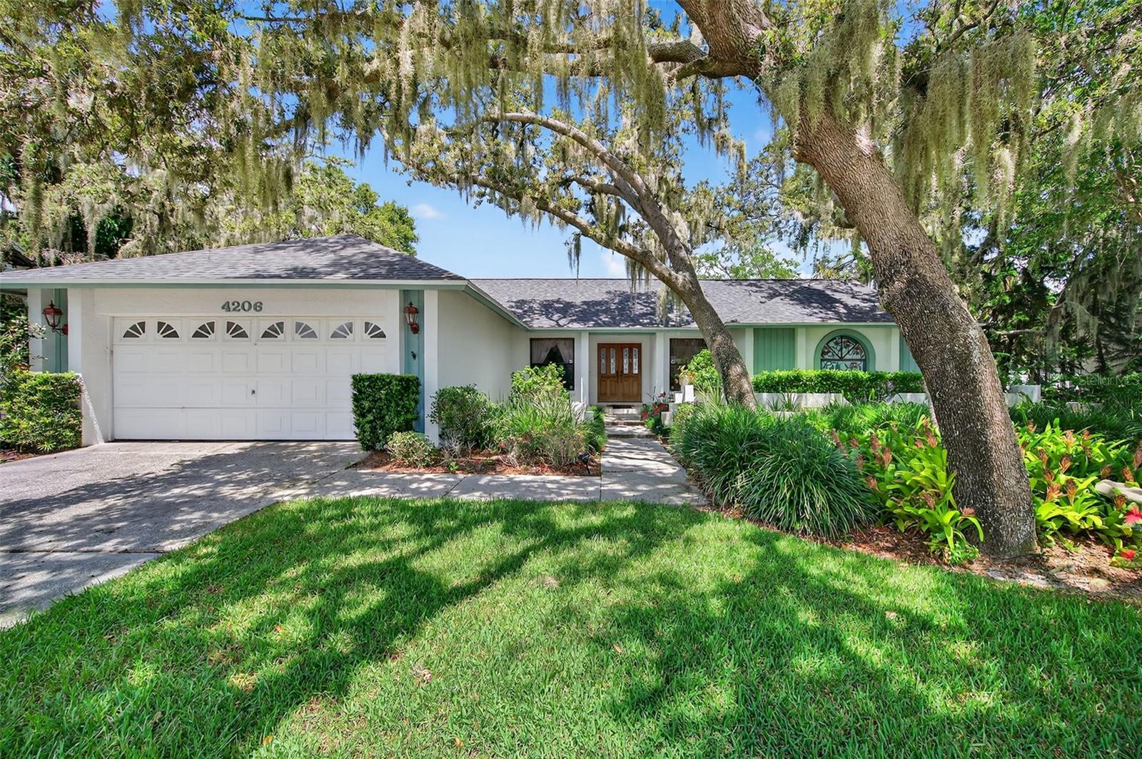 Wonderful in Walden Lake!  This ORIGINAL OWNER HOME is just waiting for you to make it your own, as #2 becomes the new #1!  4 BEDROOMS and 2 BATHS in this 2,216 square foot SPLIT FLOOR PLAN in the highly sought-after WALDEN LAKE COMMUNITY, Plant City's finest!  Nestled under welcoming, SHADY OAKS on a 1/4 acre lot, you'll feel right at home as soon as you arrive.  And you'll definitely see yourself enjoying the HUGE POOL and COVERED & SCREENED LANAI in the privacy of your SPACIOUS, FENCED BACKYARD.  Enter the beautiful wood & leaded glass front doors to a large living room / dining room with VAULTED CEILINGS and SKYLIGHTS with a QUADRUPLE SLIDER to the pool / lanai, a stunning view to impress your guests and allowing TONS OF NATURAL LIGHT.  The primary suite is on the right side of the home and features Frech doors to the pool, WALK-IN CLOSET, and en suite bathroom with DUAL VANITY, garden tub, and step-in shower.  Pocket doors lead to the adjacent 4th bedroom which can be used a HOME OFFICE or a nursery.  2 generously sized secondary bedrooms are situated on the left side of the home and offer a guest bathroom with DUAL VANITY and shower / tub combo.  The kitchen is in the rear of the home and has 3 windows to the covered pool area making entertaining a breeze!  And the kitchen opens to the inviting family room with vaulted ceilings, WOOD-BURNING FIREPLACE, built-in shelves, breakfast nook, and sliders to the pool.  The conveniently placed LAUNDRY ROOM features new WASHER & DRYER, a utility sink, storage closet, and handy folding table!  BRAND NEW ROOF gives you peace of mind, and the diligent owner has maintained the 2012 A/C system.  Popular Downtown Plant City is just a 10 minute drive - you'll love all the new restaurants, shops, and breweries, not to mention the FAMOUS STRAWBERRY FESTIVAL every year!  This home has been lovingly cared for by this 1 owner for over 30 years, and now it's your turn to take this blank canvas to the next level.  Can't wait to see what you do with it!