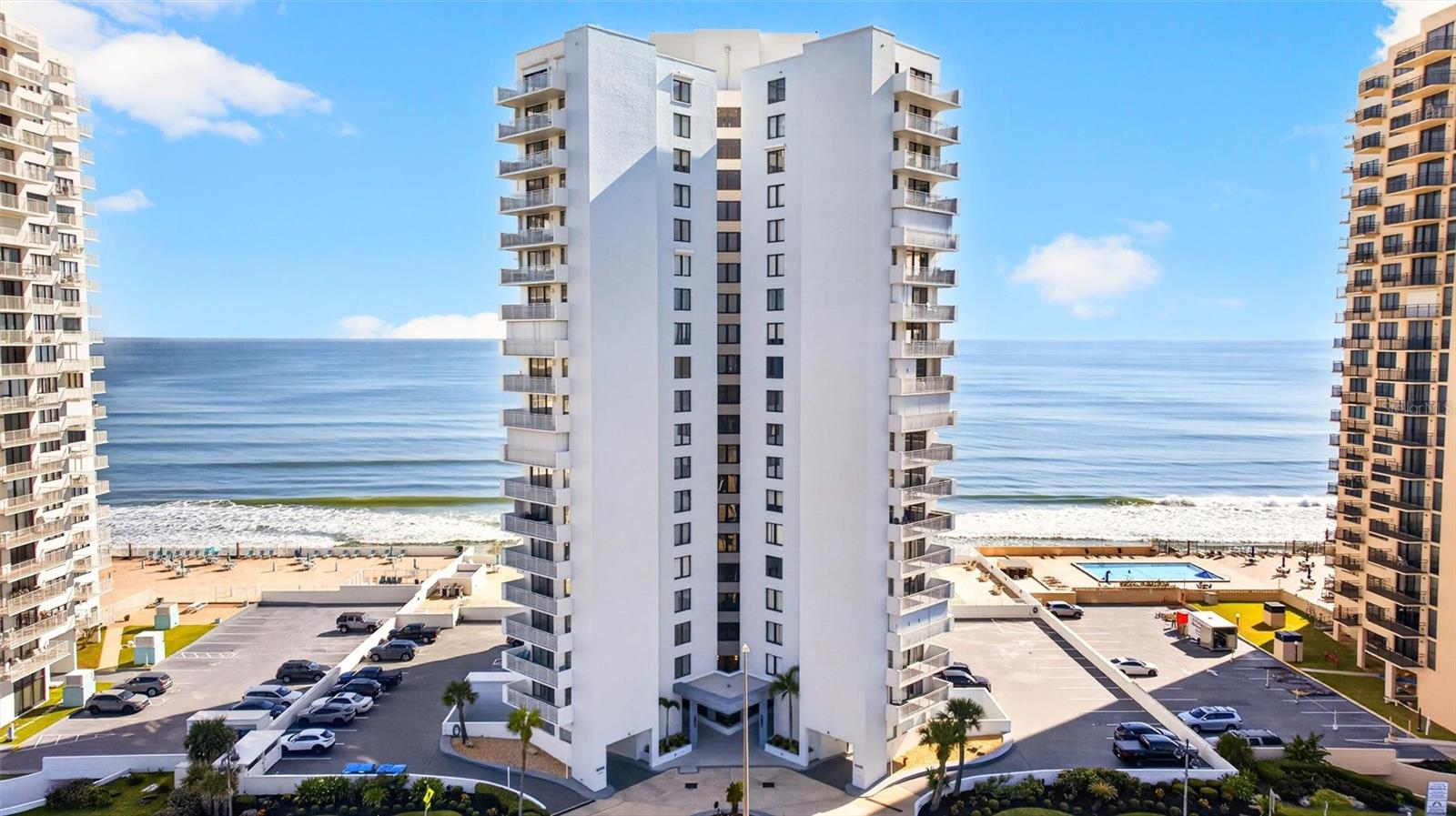 Rare 3-bedroom oceanfront opportunity in sought-after Daytona Beach Shores! Located on the 11th floor at Oceans Two, Unit 1103 offers ocean views from every window, desirable southern exposure and balcony access from two rooms. Wake up to beautiful Florida sunrises over the Atlantic, spend your days steps from the beach, and unwind in the evening as the sky changes with the sunset. Inside, the remodeled kitchen features custom cabinetry, quartz countertops, generous storage and appliances updated in 2021. Custom interior shutters add a polished coastal feel, while a 2019 A/C, 2019 water heater and updated electric storm shutters provide added peace of mind. Private storage and laundry are conveniently located on the same floor.Oceans Two offers direct beach access, an oceanfront pool and sun deck, fitness center, social rooms, outdoor grilling area, renovated lobby, on-site management and assigned underground garage parking.The location is just as appealing—enjoy nearby Oceans West Golf Club, pickleball, tennis, dining, shopping and everyday conveniences, all within sought-after Daytona Beach Shores.Whether you're looking for a full-time residence or a Florida getaway, Unit 1103 combines the space of a rare 3-bedroom floor plan with incredible 11th-floor views, thoughtful updates and true oceanfront living.