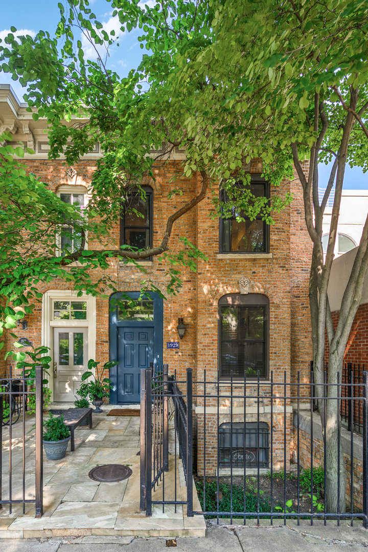 This one is an undeniable showstopper! Blending architectural character with modern sophistication, this beautifully remodeled fee simple historic Chicago brick row home situated on a quiet, picturesque, tree-lined Lincoln Park cul-de-sac is a rare offering; three levels with two separate living spaces, two outdoor spaces, a private garage, and thoughtful updates. Timeless curb appeal and an inviting front terrace set the tone. A proper entryway with chic floor tiles leads to the open and airy main living floor, featuring hardwood floors, an oversized front window and reading area, a gas fireplace, a dining space and a stylish open kitchen. An extension of the living space, the expansive back deck and the tall, leafy tree create a private outdoor oasis. Far from ordinary, a floating staircase leads to the second floor, which balances architectural distinction with everyday functionality. Two bedrooms anchor this level, accompanied by a spacious, updated, spa bathroom with a free-standing tub, heated floors, glass shower and dual sinks, with tons of natural light from the two skylights above. The lower level offers versatility, with a family room, ensuite third bedroom, and side-by-side washer/dryer. This home has been extensively updated inside and out: renovated kitchen and baths, expanded back deck, new flooring in the basement and top floor, a redesigned fireplace surround and mantel, brick work, windows, roof, skylights, and the list goes on. An incredible location, walkable to Lincoln Park's best restaurants, shops and nightlife, award-winning Oscar Mayer Elementary and Lincoln Park High School, the brown line, parks, and more!