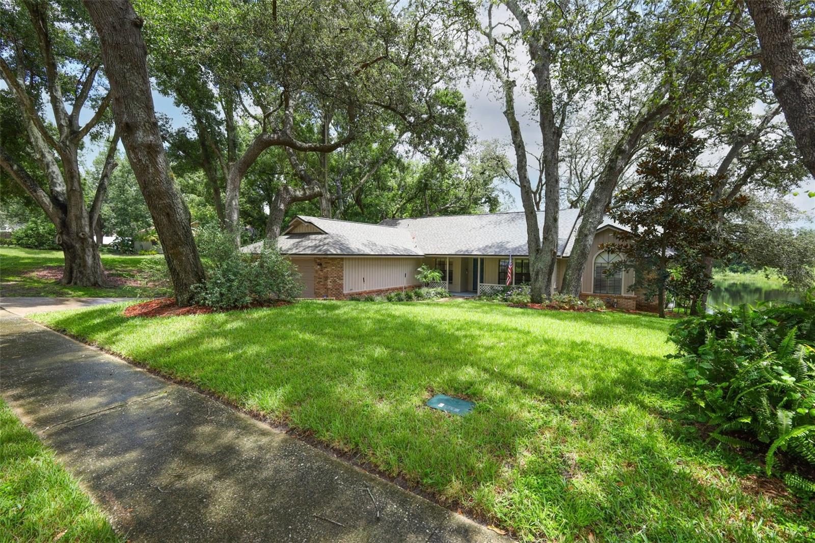 Tranquil WATER view in Rose Hill neighborhood offering 4 bedrooms 2 baths just over 2000 sq feet.  There is a unique character to this home.  ROOF 2024...GENERAC 2021.  The Primary bedroom has an En-suite bath that flows into a great flex space that would make a terrific nursery or office.  Split planned home with views in the Family room of the water.  Doors open to a high deck and you can relax and watch the ducks or enjoy your tree swing.  Stainless Steel Whirlpool Gold appliances with Quartz counter tops.  Formal Dining & Living Rooms for that extra space when entertaining.  Wood Burning Fireplace anchors the Family Room with Natural Light from the Backyard.  This home needs a few cosmetic updates which will allow you to add your own personal touches.  Plantation Shutters, Water Heater 2021, Trane AC & ceiling Fans throughout!  Elevated & Newer Ceiling Texture  & Updated Guest Bath which opens to the Rear Deck. Just under 1/2 acre of shade trees and lush landscape!
