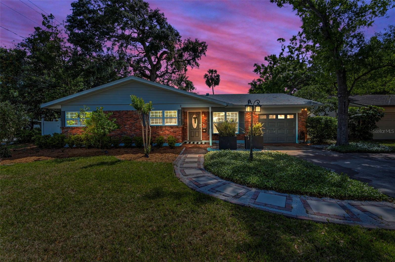 Get ready to live the Soho dream! Seize this 3 bedroom, 2 bath South Tampa home and find out why it’s one of the most desirable locations in the Tampa Bay Area. With upscale amenities like posh dining and boutiques, gorgeous parks and recreational areas, and waterfront views that make you feel like you’re on vacation every day, the neighborhood of Beach Park is waiting to be your new address. After enjoying the many activities your new neighborhood provides, retire to your new home boasting 1787 sqft. This home features all the charm and character of South Tampa architecture, but is completely updated with bright, modern features. Sitting on an OVERSIZED CORNER LOT with brick paved path framed by fresh landscaping, you’ll immediately feel welcome. Just through the front door you’ll be greeted by an open floor plan and an abundance of light coming through newer double pain windows, skylights and updated lighting throughout. With fresh modern finishes and new paint your open living and dining area will be the perfect place to entertain guests. Prepare meals in the updated kitchen which offers newer stainless steel appliances, fresh farmhouse cabinets, granite countertops, undermount sink, backsplash, and even an eat-in breakfast area which overlooks the front yard. Unloading groceries is easy with direct access to the 1 car garage through the kitchen. The kitchen has a pass through window open to the family room with a cozy, fully functional and updated wood burning fireplace. There is an additional living area with tons of windows featuring plantation shutters that bathe this tranquil retreat in fabulous Florida sunshine. Your home features a split floor plan with the primary suite on one side featuring its own bathroom with walk-in closet and stand alone shower. Two guest bedrooms on the other side of the home share a separate bathroom with soaking tub and new flooring. There is an inside utility room with washer and dryer that is large enough for a small home gym. Your backyard is a private oasis with NEW vinyl privacy fence surrounding a paved entertainment area with brick pavers, and NEW, premium artificial turf that gives a bright, aesthetic vibe to the space. In addition to the garage with plenty of storage, there is space for boat or RV parking behind a double gate in the backyard. You won’t have to worry about moving in and doing anything as this home has too many upgrades to mention… highlights include: NEW AC (2023), NEW plumbing, NEW electrical box, NEW irrigation system, New natural gas tankless water heater, newer water softener and water system, newer roof (2020) and high and dry with no hurricane damage! Zoned for Plant High School district. All that’s left to do is move in and start enjoying the South Tampa lifestyle.