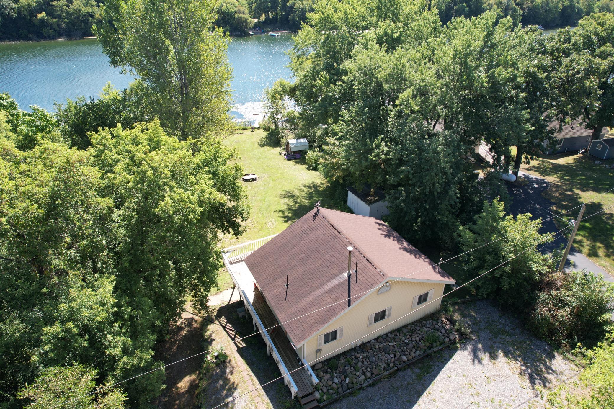 Check out this 3 bedroom, 2 bath lake home on large ½ acre lot surrounded by mature trees for added privacy.  Located on a quiet dead-end street on desirable Pirz Lake.  The spacious home has many recent updates to enjoy including updated appliances, flooring, panel doors, furnace, central air, vinyl windows and siding.  Main level features a kitchen, dining area, 2 bedrooms, living room and bathroom. You will appreciate the fully finished walk-out basement featuring a 2nd family room, 3rd bedroom, 2nd bathroom, and room for storage.  Relax and entertain on the back patio or on the huge lakeside wrap around deck.  Fiber high speed internet available. Pirz Lake is quiet with no public access and Spring fed.  Lot next door is a unbuildable government lot for extra privacy. Start creating lake memories today!!