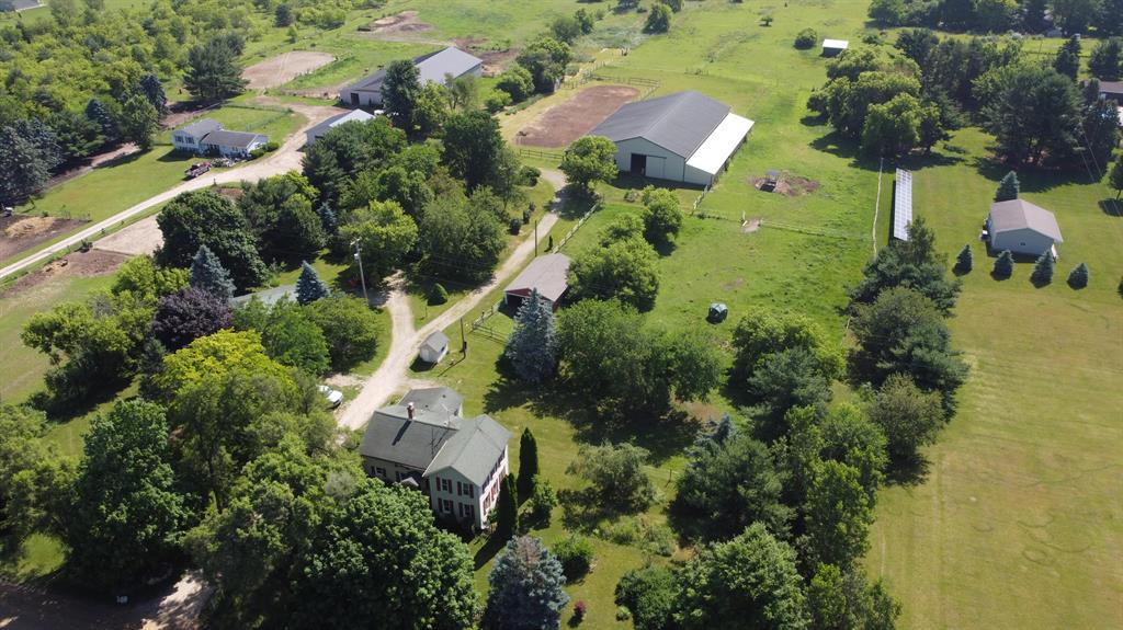 Horse enthusiasts' dream!  INDOOR RIDING ARENA!  Fantastic 4-bedroom, 2-bath home on 10 peaceful acres with endless potential! This spacious and functional horse farm offers room to spread out and enjoy a quiet, country lifestyle. Perfect for horse enthusiasts or hobbyists, the property features a massive 82' x 120' main barn with (7) 10' x 10' stalls, a full bathroom, and a 60' x 120' indoor riding arena. There's also a 60' x 120' outdoor riding ring for additional training or leisure riding.  Tons of Pasture space throughout.  Inside the home, you'll find two main-floor bedrooms and a full bath, plus two more bedrooms and another full bath upstairs. There are several other barns on the property, including a spacious pole barn near the house that is used as a 2 car garage.