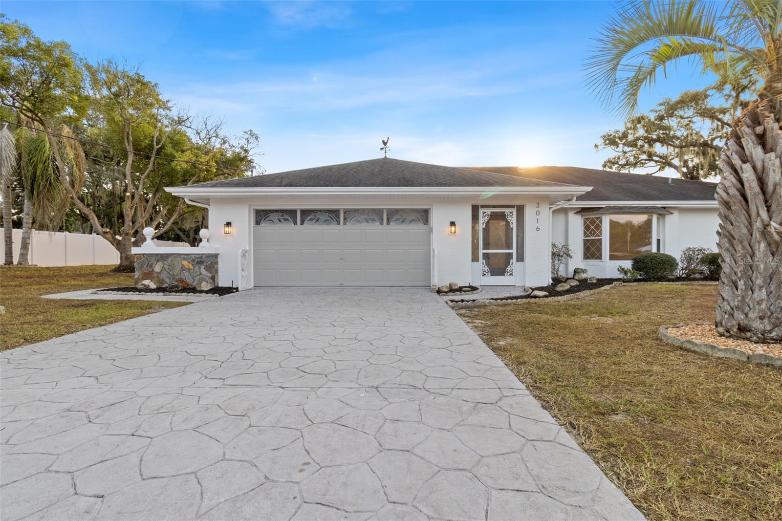 One or more photo(s) has been virtually staged. Welcome home to this beautifully updated LAKEFRONT 4-BEDROOM, 2-BATHROOM HOME with a 2-CAR GARAGE, located on FLOOD ZONE X for peace of mind. Perfectly tucked away on the peaceful WEEKI WACHEE PRAIRIE LAKE (LAKE THERESA), this property offers NO REAR NEIGHBORS, a POND AND FOUNTAIN WATER FEATURE, and tranquil NATURE AND LAKE VIEWS that shift beautifully with the seasons.

This home features a SPLIT FLOOR PLAN with an OPEN FAMILY ROOM AND DINING ROOM COMBO, a separate LIVING ROOM, and a DINETTE, offering plenty of space for entertaining or relaxing. Inside, you’ll find BRAND-NEW FLOORING, FRESH PAINT INSIDE AND OUT, and UPGRADED KITCHEN AND BATHROOMS designed with modern finishes. The ELECTRIC-CONVERT FIREPLACE adds a peaceful warm glow and character, creating a cozy atmosphere throughout.

Take advantage of THREE SCREENED PORCHES—TWO REAR SCREENED PORCHES overlooking the peaceful landscape and ONE FRONT SCREENED PORCH; all beautiful spots for your morning coffee. Unwind year-round in the IN-GROUND HEATED SPA, surrounded by the sights and sounds of nature.

With a NEW 2025 HVAC SYSTEM, a 2020 WATER HEATER, and thoughtful updates throughout, this home blends comfort, functionality, and serenity. Whether you’re seeking a full-time residence or a quiet weekend escape, this property offers the best of FLORIDA LIVING—SPACE, COMFORT, AND NATURAL BEAUTY.

Schedule your private showing today and experience the tranquility of LAKE THERESA living!