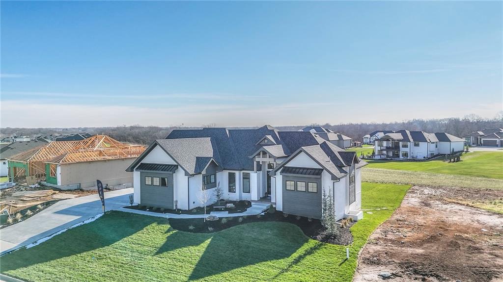 Welcome to the beautiful Silverstone floor plan by JW Thomas, a thoughtfully designed 3,372 SF custom home perfectly blending elegance, function, and comfort. Situated on a walkout lot overlooking peaceful greenspace, this 4-bedroom, 2 full and 2 half-bath home offers an incredible lifestyle in one of the most desirable communities - Lake Winnebago, MO.Step inside to discover a spacious, light-filled layout with designer finishes throughout. The gourmet kitchen is a dream for any home chef, featuring a prep kitchen with built-in mixer lift and storage, produce drawers, an oversized refrigerator, professional grade Frigidaire appliances with double ovens, and abundant custom white oak cabinetry. The open living area with gorgeous beams, flows seamlessly to a tiled back deck with fireplace, accessible through multiple sliding doors, creating a perfect space for entertaining or unwinding while enjoying the view.The primary suite is a true retreat, showcasing a massive walk-in closet with built-in storage and convenient pull-down racks. The luxurious master bath includes heated tile flooring, where every lighting detail has been thoughtfully designed.  Downstairs, the finished lower level offers a built-in bar and unique nook ideal for game nights. The covered stamped patio below mirrors the serenity of the deck above, overlooking the greenspace.  You will also find 2 additional generously sized bedrooms with walk-in closets, and a 3rd bedroom finished with fitness in mind.The 3-car garage with belt drive garage openers provides plenty of room, including a bay large enough for your boat, perfect for Lake Winnebago living.Enjoy all the community has to offer: a brand new resort-style pool, horse stables, restaurant, parks, walking trails, tennis and basketball courts, and year-round community events.This home combines thoughtful craftsmanship, luxury touches, and the unbeatable Lake Winnebago lifestyle. Don’t miss the chance to make it yours!