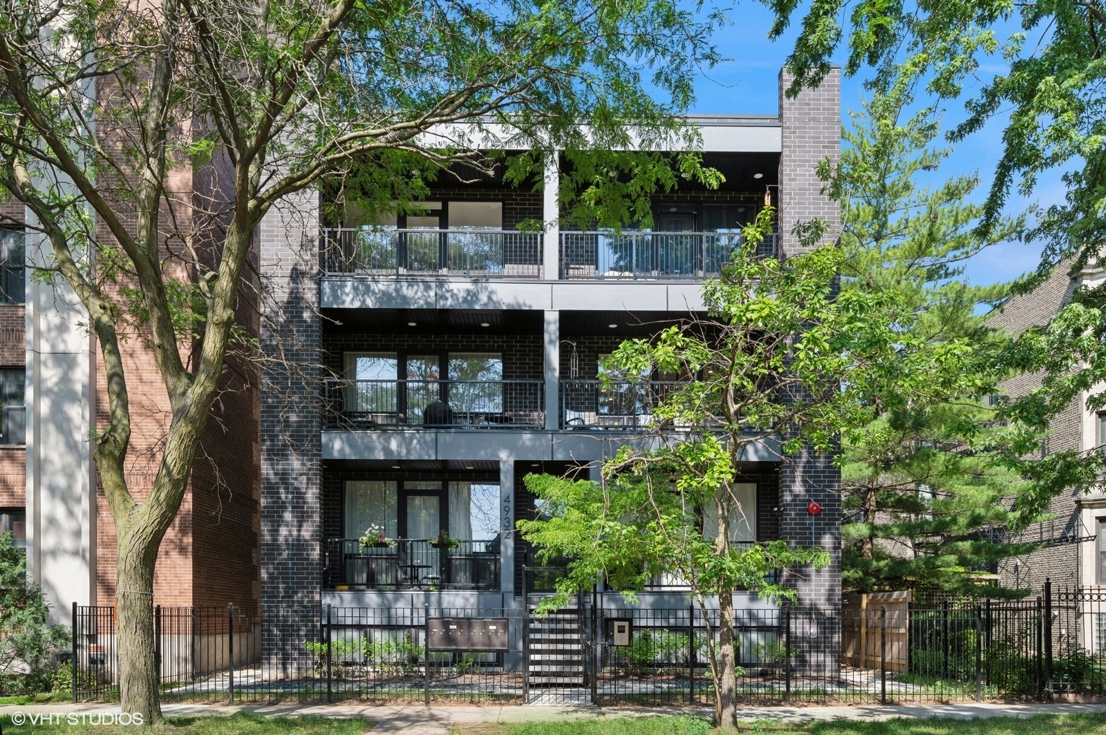 Welcome to 4932 N Kenmore Ave Unit 2N, a 3 bedroom, 2 bathroom condo in a newer building. Built in 2023, this stunning condo features an open floor-plan with an extra-wide living and dining area-perfect for entertaining or relaxing in style.  From the living room step outside onto the front balcony, which spans the entire width of the unit and features durable composite decking with peaceful treetop views-your own private escape in the city. Back inside, the chef's kitchen boasts custom cabinetry with updated pull-out shelving, quartz countertops, and a spacious breakfast bar ideal for casual dining. The king-sized primary suite offers a serene retreat with a walk-in closet, custom remote-controlled blackout blinds, and an ensuite bath featuring double sinks. The generously sized second and third bedrooms each include custom closet organizers for efficient storage.  Other updates include new paint throughout the condo in 2025, custom remote Hunter-Douglas blinds in the living and dining rooms, and a designer fan installed in the master bedroom. One garage parking space is included. This is a rare opportunity to own a beautifully appointed home in a prime Uptown location. Just steps from the Argyle Red Line, the 36 Broadway bus, and beloved local favorites like Tank Noodle, Sun Wah BBQ, and First Sip Cafe, this condo offers both comfort and unbeatable Uptown convenience. Come Home!