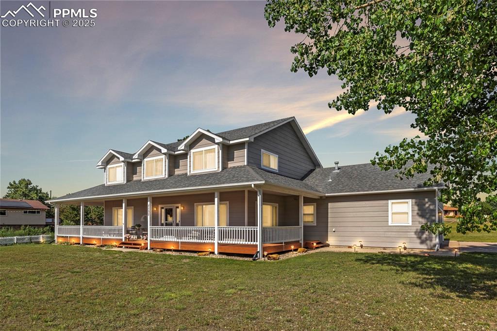 ONE ACRE LOT with VIEWS of the MOUNTAINS from the expansive front deck of this Colonial Style Home! Dreaming of a semi-rural lifestyle in the heart of the city? Your homestead awaits in The Falcon Estates. This coveted neighborhood blends urban convenience with country living. Perfect for those craving city amenities with a rural touch, this rare 4-bedroom, 3-bathroom home with a 3-car garage is the home you have been waiting for. Nestled on a ONE-ACRE corner lot, this property provides ample space and privacy. Inside, you'll find an open-concept main level with new carpet and interior paint. An inviting living room with mountain views flows seamlessly into the kitchen and formal dining room. The kitchen features granite countertops, a stone-accented breakfast bar, newly refaced white cabinets, stainless steel appliances, and updated lighting. The main level also includes a large sitting room or second living room with mountain views, access to the three-car garage, a powder room and a cozy office with french doors. Sliding glass doors open to a backyard complete with a relaxing patio, and the open backyard offers plenty of room to garden, have chickens, or entertain. Upstairs, an expansive master suite offers a true retreat with its en-suite bathroom. Three additional bedrooms and a full bathroom complete the upper level (All FOUR bedrooms on the upper level bedrooms –a rare find!) This home's appeal extends beyond its walls: situated in the highly sought-after D-20 school district, its minutes from dining and shopping at Falcon's Landing and other establishments on Academy Boulevard. Nature lovers will appreciate the short drive to stunning outdoor spaces like Ute Valley Park and Blodgett Peak. Recent upgrades include fresh interior and exterior paint, new carpet, solar panels, granite countertops in the kitchen, and new light fixtures on the main level. Even more, imagine adding a large steel barn shed for your toys on this level 1-acre property.