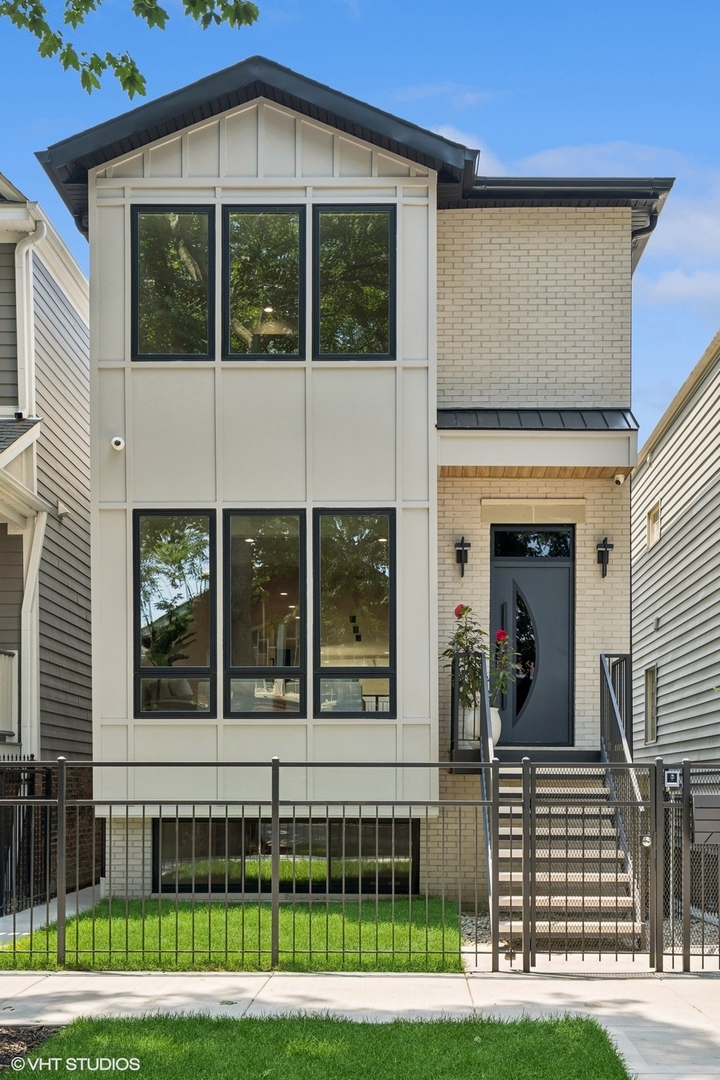 Newly completed West Lakeview 5-bedroom, 4.2-bath single-family home with elegant architectural flow, natural materials, and curated finishes. The oversized entry and formal sitting area features coffered ceilings, powder room with made-to-order Calacatta Viola Antique Marble Sink. The unforgettable chef's kitchen features a 16' island with Taj Mahal marble, paneled Thermador appliance suite, Emtek pulls, custom cabinetry, walk-in pantry, and fluted accents. Living room expands to the custom made steel deck and composite decking, and garage-top deck with enclosed pergola. The primary includes dual walk-in closets, spa-quality en-suite bath with Aqua Quartzite dual sinks, Victoria+Albert soaking tub, spa shower, radiant heated floors and artisan tile selections including a Verde Tia marble niche and Baltic sandstone. The second level has two additional bedrooms, a Jack-and-Jill bath with Aqua quartzite sinks, natural stone finishes, and radiant heated floors. The utility room and laundry closet with storage complete the level. The lower level offers an expansive family room, 10' high ceilings, wet bar, Zephyr beverage cooler, finished with a leathered Onyx quartzite marble counter. Level also includes powder room, two bedrooms, each with radiant heated floors in en-suite baths and custom closets, and full-size laundry room. Additional features include a 400-amp electrical service (garage subpanel, EV ready), main and lower level pre-wired for 5.2 surround sound, 2 electric fireplaces, custom closets throughout, oversized windows, 4K full parameter camera system, and smart home integrations. Located directly across from the Hamlin Park clubhouse, pool, tennis courts, and dog park. Enjoy easy access to Costco, Whole Foods, Target, Belmont CTA, Roscoe Village shops and restaurants, and an abundance of green space.
