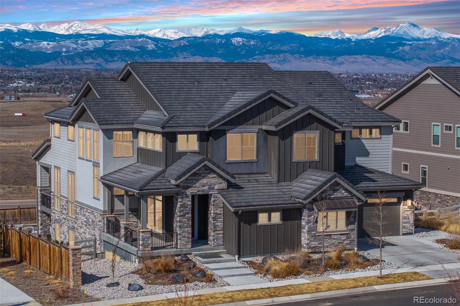 Welcome to 15325 King Ct, an exceptional luxury residence in the highly sought-after Anthem community, offering 7 bedrooms, 7 bathrooms, & a 3-car garage with breathtaking Front Range mountain views & a premier lot siding to a park. Designed for both elegance & innovation, the home features whole-home Cat6 wiring, surround sound, remote blinds, & a tankless water heater. The dramatic great room showcases soaring ceilings & a Cosmo gas fireplace wrapped in black marble, framed by expansive windows capturing Colorado views. The chef’s kitchen is equally impressive with a Wolf gas range, Miele built-in coffee system, Miele microwave, walk-in pantry, quartz countertops, marble backsplash, & oversized contrasting island. A sophisticated wet bar with beverage fridge, sink, & custom floating shelves makes entertaining effortless. A private glass-enclosed office features soundproofing & an imported moss wall, creating a striking workspace. The main-floor mother-in-law suite offers a wood slab accent wall, built-in dresser, private 3/4 bath, & direct deck access with mountain views. The mudroom includes built-ins, designer wallpaper, custom Roman shades, & walk-in closet. Upstairs, the primary retreat features tray ceiling, custom wallpaper, Cosmo fireplace, private covered deck with mountain views, & spa-inspired 5-piece bath with chandelier-lit water closet, wet room with freestanding tub & oversized shower, & walk-in closet. 3 additional bedrooms each include private ensuite baths, plus upstairs laundry. The finished basement provides a bedroom, gym, & flex space with wet bar with wine/beverage fridge, sink, & dishwasher, with walk-out backyard access. Outside, enjoy resort-style living with heated saltwater pool, custom gas firepit, natural gas line, & multiple outdoor spaces overlooking the mountains. A rare opportunity to own a fully integrated luxury home in Anthem combining design, technology, & Colorado views.