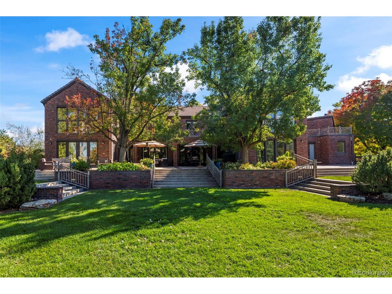 Set on one of the most coveted lots in prestigious Somerset Estates, this exceptional estate offers a rare blend of privacy, scale & sweeping Front Range views. Tucked at the end of a private cul-de-sac on 1.10 ACRES, the home is introduced by a circular drive and covered entry, setting the tone for the refined interiors within. A striking double staircase defines the foyer, leading to expansive living & entertaining spaces. The grand 2-story living room features soaring ceilings, a statement fireplace, and wall of windows that frame the surrounding landscape. Just beyond, a dedicated home theater w/ built-in seating creates the ultimate setting for movie nights. The gourmet kitchen is thoughtfully designed for both everyday living & elevated entertaining, complete with center island & Thermador appliances-including gas range & walk-in pantry. Adjacent spaces include a family room w/ fireplace & serene sunroom wrapped in windows, offering uninterrupted views year-round. Upstairs are 4 generously sized bedrooms w/ ensuite baths for optimal comfort & privacy. The luxurious primary suite serves as a private retreat, with a view deck, fireplace w/ stone surround & 6-piece bath featuring a large walk-in steam shower, dual vanities & jetted tub. Impressive walk-in closet w/ rich custom built-ins connects to a private executive office with its own powder bath. A 2nd primary suite with 5-PC bath provides ideal accommodations for guests, extended family, or nanny. The lower level offers a versatile space perfect for home gym or studio, along with abundant storage. Car enthusiasts & hobbyists will appreciate the oversized, heated 4-car garage with convenient access to multiple mudrooms. Multiple patios & beautifully curated landscaping create an ideal backdrop for entertaining or simply enjoying Colorado's natural beauty. Ideally located minutes from charming downtown Niwot, an extensive network of trails, and top-rated schools. This is Colorado living at its finest.