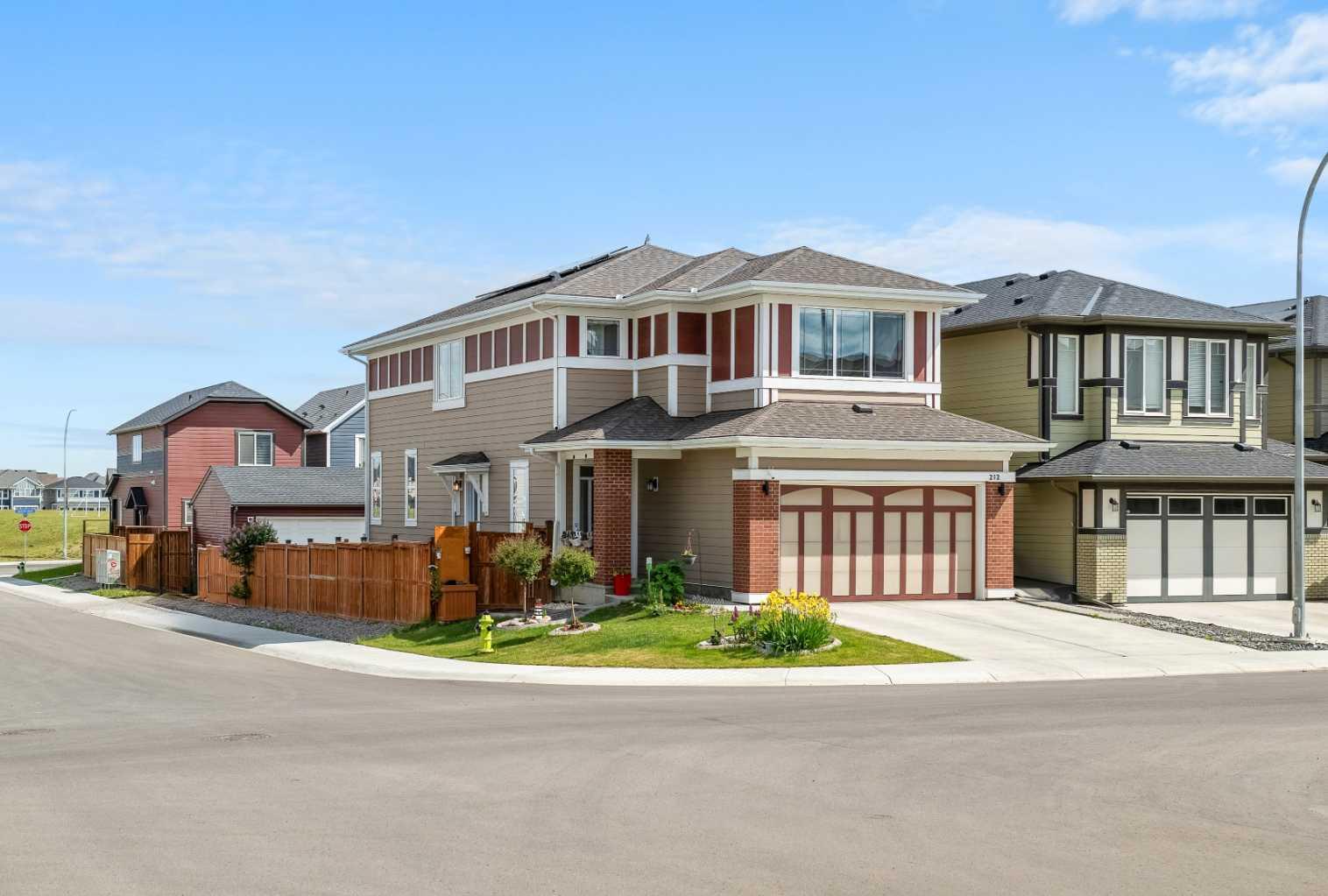 Welcome to your next chapter in Mahogany, where MODERN ELEGANCE meets EVERYDAY FUNCTIONALITY. This stunning 4-BEDROOM, 3-BATHROOM home is perfectly situated on a CORNER LOT WITH A BACK ALLEY, directly across from peaceful GREEN SPACE. You’re just a 10-MINUTE WALK TO THE LAKE, BEACH, and BEACH CLUB, with nearby access to SCHOOLS, PARKS, SHOPPING, DINING, and the WETLANDS—all in one of Calgary’s most sought-after lake communities.

The inviting main floor offers a BEDROOM WITH A POCKET DOOR TO A FULL BATHROOM, ideal for guests or MULTIGENERATIONAL living. The open-concept layout flows seamlessly from the DINING AREA into the LIVING ROOM. The showpiece kitchen is outfitted with WHITE CABINETRY and GRANITE COUNTERTOPS, complete with a GAS COOKTOP, BUILT-IN MICROWAVE AND OVEN, HOOD FAN, DISHWASHER, and a COLOURED GRANITE SINK—all INCLUDED for your convenience. A WALK-IN CORNER PANTRY and large island make this space as functional as it is beautiful.

Upstairs, you’ll find three generously sized bedrooms, including a PRIMARY RETREAT and bathrooms featuring QUARTZ COUNTERTOPS. Each bedroom includes CUSTOM CLOSET BUILT-INS that maximize organization and storage. The UPPER-LEVEL LAUNDRY AREA includes a WASHER & DRYER, and select WINDOW COVERINGS—some REMOTE CONTROLLED— are also INCLUDED, offering comfort and ease at your fingertips.

A SIDE ENTRANCE WITH A DEVELOPED STAIRWELL offers future development potential, and the 9’ BASEMENT CEILINGS create a bright, open feel downstairs. Practical enhancements include TWO FURNACES, a TANKLESS WATER HEATER, and SIX INSTALLED SOLAR PANELS that help reduce long-term energy costs. The ATTACHED GARAGE is ROUGED-IN FOR GAS, offering the option to add a heater for year-round use. A FREEZER IN THE BASEMENT is also INCLUDED.

Step out onto your BALCONY WITH ALUMINUM RAILING—a perfect place to unwind and enjoy the surrounding community. With SCHOOL BUS STOPS JUST TWO MINUTES AWAY, and both PUBLIC AND CATHOLIC SCHOOLS within walking or biking distance, this home is perfect for families. Enjoy EASY ACCESS TO DEERFOOT AND STONEY TRAIL, connecting you effortlessly to the rest of the city.