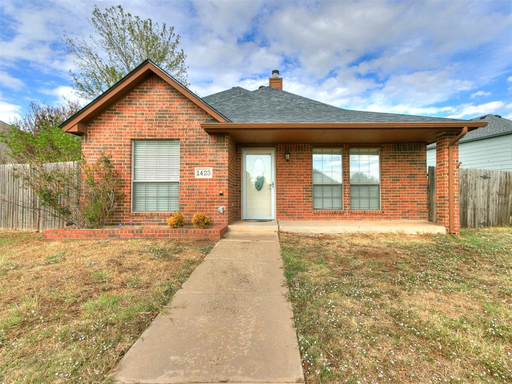 Well-kept two-story brick home in Moore with a dramatic vaulted living room, exposed beam, and a fireplace flanked by built-in shelving. The kitchen opens to the main living space with rich dark cabinetry, stone counters and backsplash, a center island, and a full appliance package. Large tile runs through the main living areas, with warm wood flooring in the bedrooms and upstairs. Roof and HVAC were both replaced in the last few years. Out back, a covered patio and fully fenced yard, with an attached two-car garage off an extended concrete drive. Seller is a licensed agent.
