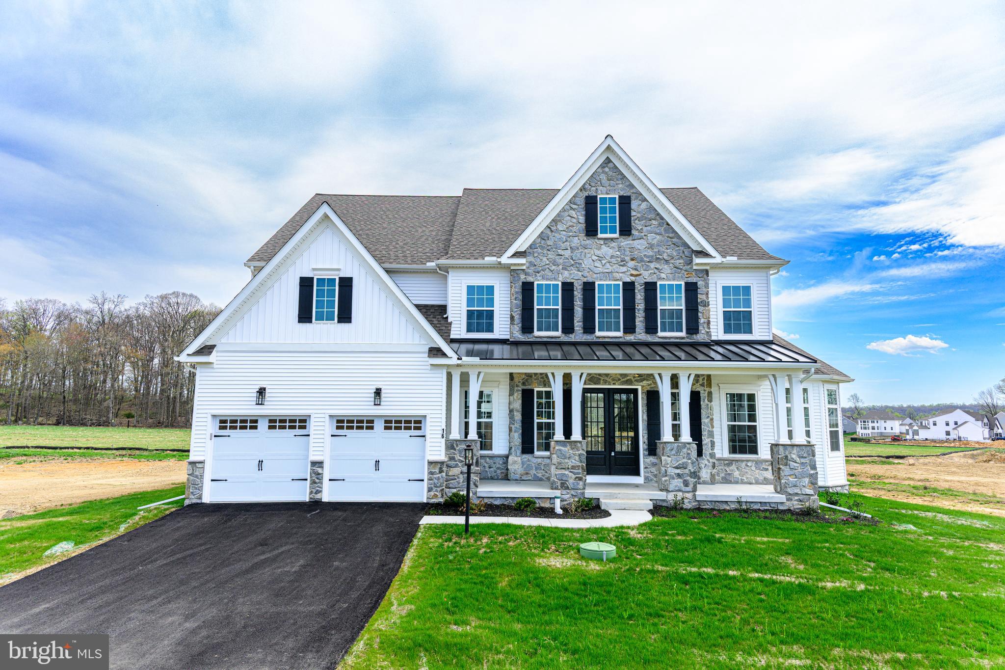 ALSO AVAILABLE TO RENT FOR $7,000 PER MONTH.  Ask agent for details.  Welcome to 16 McKnight Farm Lane in Glenmoore! Located in the highly desirable Trails at Marsh Creek community and within the award-winning Downingtown Area School District, this brand-new home is ready for immediate occupancy and has never been lived in. --- This spacious 5-bedroom, 3 full bath, 2 half bath home offers a flexible floor plan designed for modern living. A main-level in-law suite with a full bath provides the perfect setup for privacy and easy, step-free access. The open-concept main living area features a dramatic two-story family room that flows seamlessly into the kitchen with a large eat-in island and walk-in pantry—ideal for everyday living and entertaining. --- Upstairs, you’ll find four additional bedrooms, including a generous master suite with two walk-in closets and a private bath. The laundry room is conveniently located on the second floor. The walk-up basement is built for entertaining, complete with a wet bar and powder room. --- Situated just minutes from Marsh Creek State Park, major routes including I-76 and Route 322, and close to Downingtown and Exton shopping and dining, this home offers space, flexibility, and a prime Chester County location. --- Brand new. Move-in ready. No waiting, no construction delays. --- All the benefits of new construction without the wait!