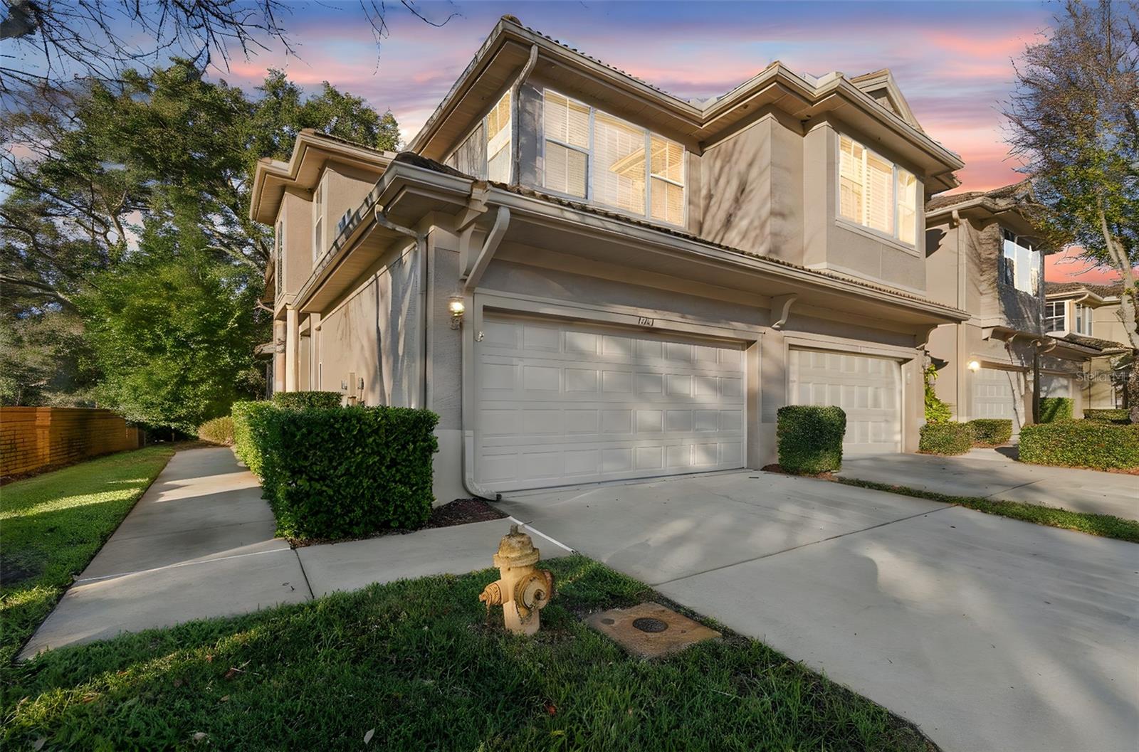 Live the Dunedin lifestyle — just a golf cart ride to the heart of Downtown Dunedin! First-Floor Primary Suite! Volume Ceilings! Screened-In Patio with a Spacious, Tree-Lined Backyard! This light and bright end-unit townhome offers an inviting layout with generous living spaces and a seamless blend of comfort and style. Enjoy tranquil views from the screened-in porch overlooking a lush, grassy backyard—an ideal setting for relaxing or entertaining. Recent updates include luxury vinyl plank flooring, new carpeting in the bedrooms and loft, and new stainless steel range, microwave, and refrigerator, along with a Trane A/C (2023) and new water heater (2023) for peace of mind. The home also features a first-floor laundry room conveniently located off the kitchen, a main-level half bath, and a two-car garage with ample space for a golf cart. Low HOA fees include community pool space, exterior maintenance, and landscaping, offering easy, low-maintenance living. Ideally located just 1.6 miles from Downtown Dunedin, you’ll enjoy quick access to award-winning dining, craft breweries, waterfront parks, marinas, festivals, and all the charm that makes this area so desirable. Come live the lifestyle at the Townhomes of Weathersfield!