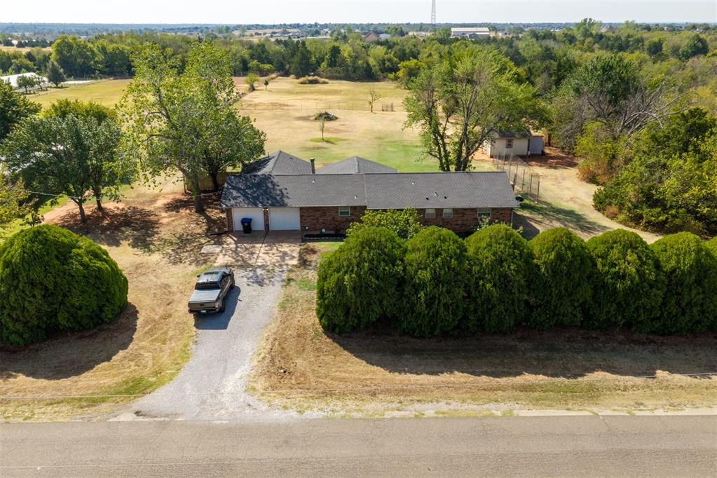 2.5 acres of flat, usable land in Deer Creek Schools! This 4-bedroom, 3-bath home with a 2-car garage offers plenty of space inside and out, plus a $5,000 seller credit. The added large studio-style 4th bedroom provides excellent flexibility as guest quarters, a private office, study, workout room, or additional living space with a full bath and separate entrance. (No traditional closet.)The property features mature trees along the front and back, multiple fruit trees, a flourishing garden, wild blackberries, two chicken coops, and an in-ground storm shelter conveniently located just outside the back patio. Recent updates include brand-new gutters, newer HVAC condenser and water heater, updated landscaping and fencing, fresh interior paint throughout, and more.An extensive list of items will remain with the property, including the washer, dryer, refrigerator, 10,000-watt generator, riding lawn mower, mower lift, weed eater, two chicken coops, and safe. Furniture may also be available if the buyer is interested.This is a hard to find combination of acreage, flexible living space, recent improvements, and valuable extras, all within the Deer Creek School District!