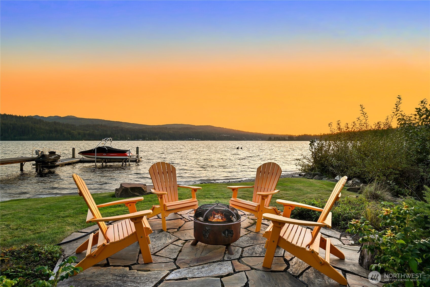 One of Lake Whatcom's most unique properties with epic views and sunsets offering unparalleled privacy with 120 feet of no bank waterfront and a picturesque creek. From the show stopping entry gate to the rusted steel garage doors, this property is the thoughtful and artistic result of a collaboration of Northwest architects, metalsmiths, artists, and constructed without a budget in mind. With over 4,000 sqft, features include a stunning steel and concrete staircase, exposed steel beams, sumptuous primary suite with fireplace and hot tub, heated concrete floors, soaring wood ceilings, boat and jet ski lifts, additional fenced parking area, and so much more. Enjoy THE ultimate lake house with a rare drive-thru boat house and boat launch!