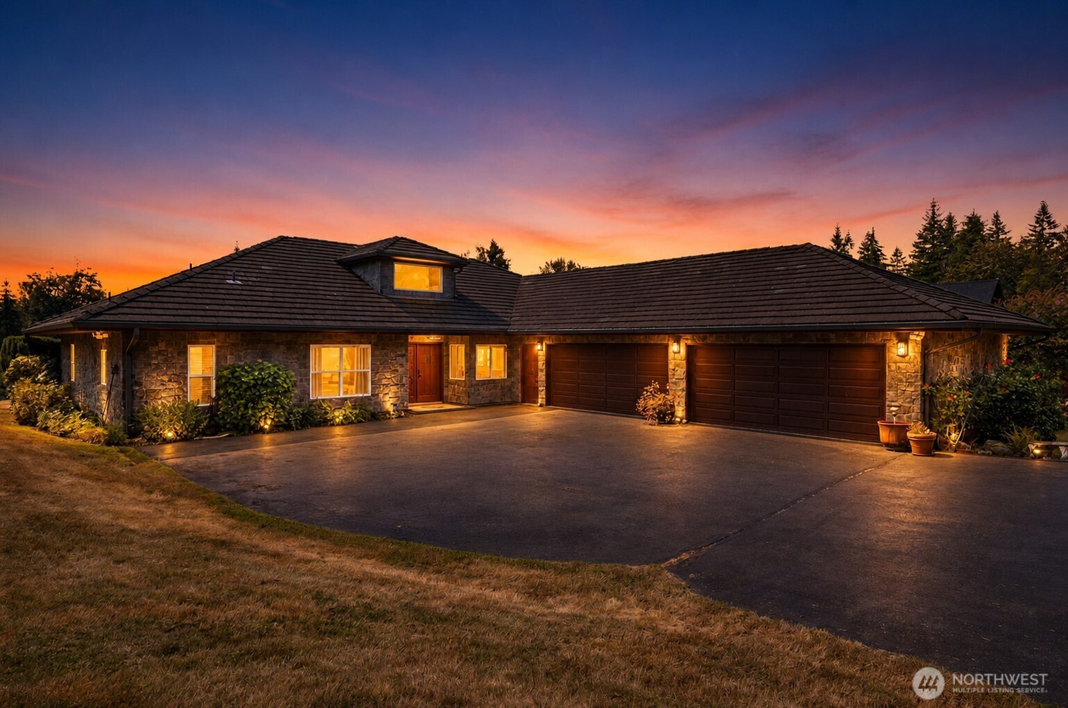Welcome to this exceptional 3.25-acre home on a private dead-end street in the Tahoma School District. This impeccably maintained 1994-built 1.5-story home features 2,410 sqft of main-level living with stunning stone exterior, keeping the home cool in the summers. Enjoy mountain and territorial views from this secluded, rolling property complete with barn, fully fenced double paddocks, and outbuildings. The open layout offers hardwood floors, granite counters, and a kitchen with eating space. The main-floor primary suite includes a bath with jetted tub, double walk-in closets, and double pane windows throughout. A walk-in pantry, built-in vacuum, gas fireplace, and security system adds to the accessible design with wide doorways and hallways on the main level. Upper bonus room provides flexible space for guests or hobbies. Propane forced air plus a cozy propane stove keep you warm, with an owned propane tank and generator-ready wiring for peace of mind. The oversized partially heated 4-car attached garage (1,134 sqft) plus RV parking handles all your toys and equipment. Terraced garden space, wooded areas, and pasture offer endless outdoor possibilities. Public water via Cedar, PSE power. A rare opportunity for country living minutes from Renton conveniences.