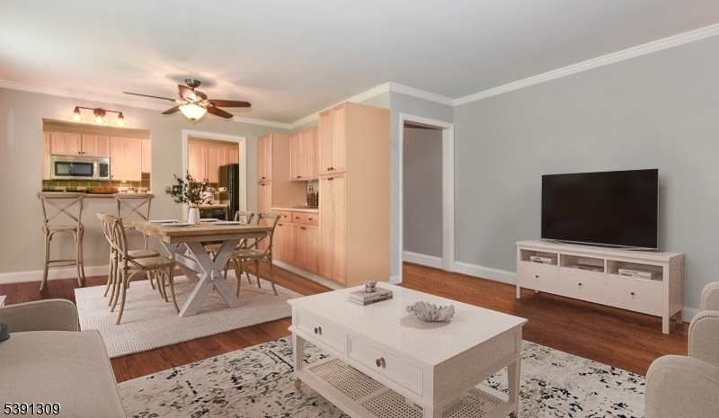 Prime Parkway Village Location! This beautifully maintained first-floor condo offers unbeatable convenience with easy street access and ample parking. Featuring 2 spacious bedrooms, this home showcases refinished hardwood floors throughout and elegant custom crown molding. The kitchen flows seamlessly into the dining area and living room, complete with a reclaimed wood breakfast bar, updated lighting, and a stylish butler's pantry providing extra storage. The bathroom has been tastefully renovated with a bright, fresh design. The primary bedroom includes two closets, and both bedrooms feature ceiling fans. HOA fees cover heat, water, and a dedicated basement storage unit. Close to parks, schools, and major commuting routes, this condo combines comfort, style, and a fantastic location.