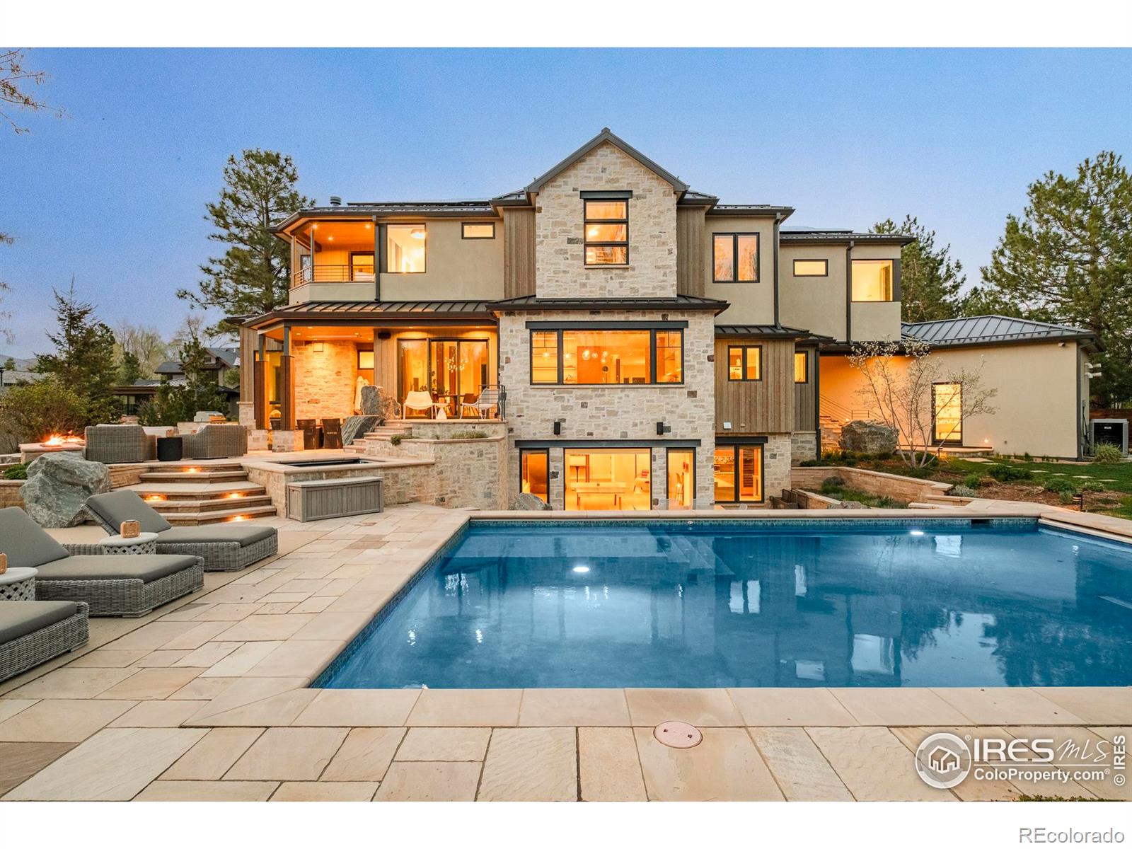 A peaceful, private sanctuary in Boulder's coveted Field of Dreams neighborhood, this remodeled residence on .91 acres blends luxury design with effortless functionality. The floorplan opens with a showstopping curved staircase flanked by a formal dining space and multiple lounging vignettes. Soaring floor-to-ceiling windows invite natural light and showcase sweeping forest and mountain views, while a thoughtful floorplan flows to an outdoor oasis featuring a saltwater pool, spa, double fireplace, infrared heat, built-in grill and expansive patio. A chef's kitchen with butler's pantry anchors the main level, complemented by 10" French oak floors and multi-zonal radiant in-floor heat. Upstairs, the luxe primary suite boasts a private balcony, sitting nook and brand new, spa-like 5-piece bath. The walk-out lower level is a dream for entertaining, complete with a custom wet bar w/ wine storage, ice-maker, dishwasher, home theater and direct access to the pool area. Smart energy features, beamed and vaulted ceilings, Control4 system, security systems and designer finishes elevate every space. The front lot is a buildable lot and a great opportunity for a compound. The adjacent lot at 2160 Tamarack Ave is also included, offering rare privacy just moments from downtown and Four Mile Creek open space.