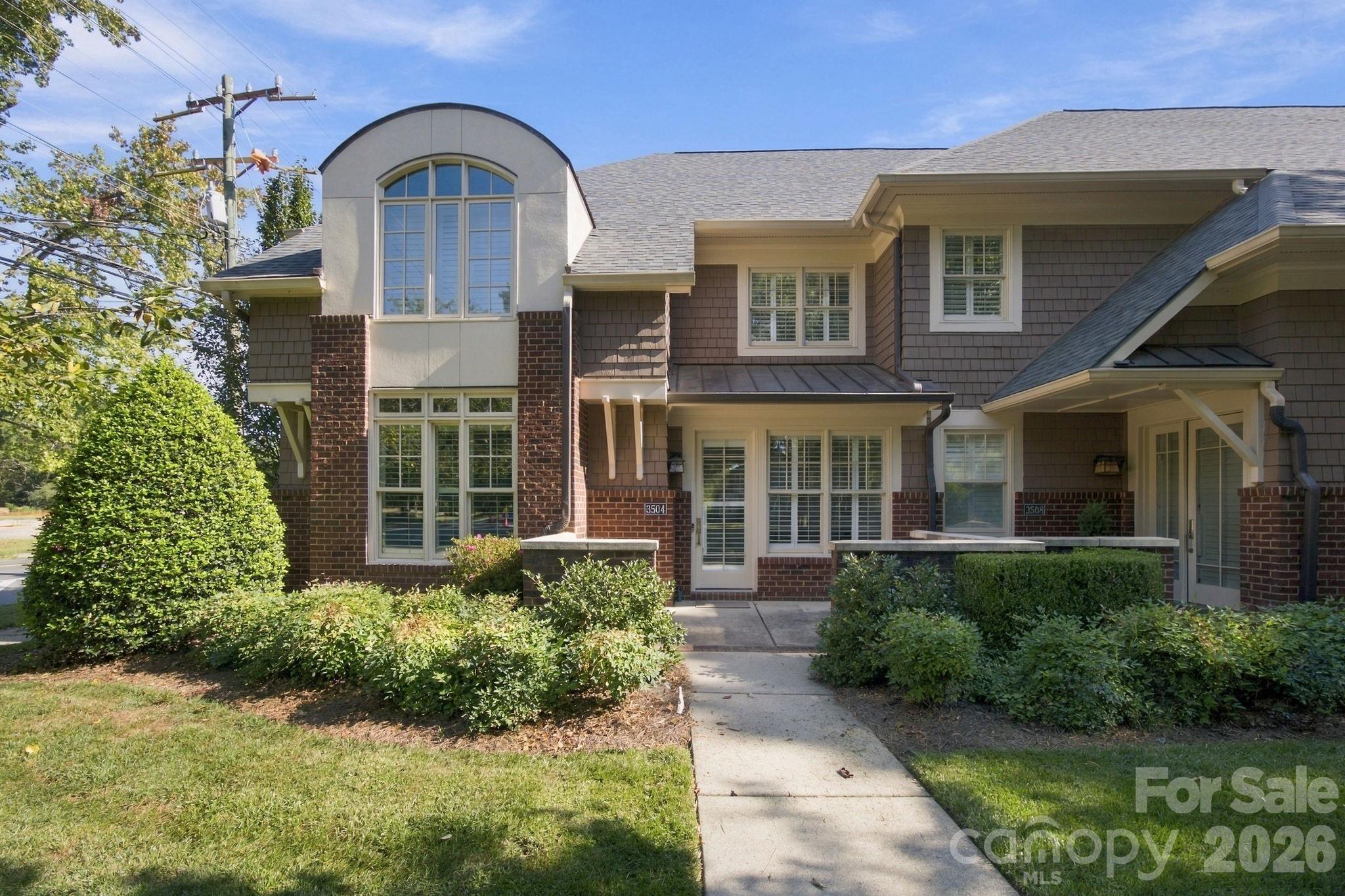 Enjoy comfortable living in this spacious 4-bedroom, 2.5-bath townhouse located in the Bradbury Hall community. Situated in the heart of SouthPark, this 2,424-square-foot home is part of a small enclave of brick townhomes that offers a truly luxurious feel. Step inside to find a functional layout boasting a main-floor primary suite for ultimate privacy, a kitchen designed for everyday convenience, and a separate dining area. The dramatic living room shines with soaring two-story ceilings, elegant plantation shutters, and a warm fireplace, while a secondary-floor loft overlooks the space below. Three additional bedrooms provide excellent flexibility for guests or a home office. Outside, relax on your quaint, bricked-in back patio or take advantage of the home's unparalleled walkability. You are just a short stroll from SouthPark Mall, Symphony Park, local dining, shopping, Park Road Park, two greenways, and the Fairmeadows Swim Club. A quick bike ride connects you to even more parks Best of all, enjoy low-maintenance living with an HOA fee that fully covers landscaping, water, and convenient weekly trash and recycling pickup.