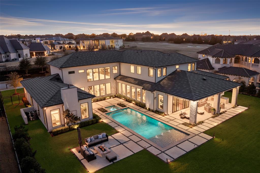 Set high above the fairway in the prestigious gated community of Wimberly Place, this custom estate offers unmatched privacy and sweeping views of the Twin Creeks golf course. Situated on a 0.7-acre premier golf lot, the newer construction makes full use of the expansive footprint while leaving plenty of grass space for further enjoyment and relaxation. Blending transitional architecture with modern accents, this home reflects today’s most desirable design trends with timeless appeal. Enter through the tall French iron doors into a light-filled interior where floor-to-ceiling walls of glass showcase the resort-style pool and outdoor living areas. Experience seamless indoor-outdoor flow, perfect for the entertainer. 
Chalky white museum-smooth walls and wide-plank white oak floors allow for a gallery-like backdrop for art collections, offering an array of furniture vignettes for everyday gorgeous living. The open-concept kitchen, breakfast area, and family room seamlessly connect with a large bar, theater, and butler’s pantry- perfect for hosting large gatherings or enjoying quiet nights in. The oversized primary suite offers a private retreat with a spa-like ensuite bath, while a separate junior primary in-law suite is thoughtfully positioned on the opposite wing of the home for flexibility and privacy. Upstairs, a spacious lounge and game area connects to three well-appointed ensuite bedrooms, creating an ideal layout for modern living.
Built with extraordinary attention to detail and structural integrity, the home is engineered with over 100+ piers, foam insulation, a concrete tile roof, imported stone flooring, select white oak floors, Level 4 countertops, Wolf-SubZero appliances, built-in Miele coffee maker, two dishwashers, designer lighting, and tankless water heaters. A wonderful opportunity to own a premier estate in the highly regarded Allen ISD and exclusive gated golf course community of Twin Creeks.