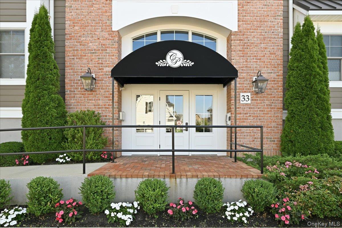 Welcome to this exceptional second-floor Dorchester model, a rare corner unit offering two distinct panoramic views of the Country Pointe community, including a serene pond vista and sweeping neighborhood views from two private balconies. An open layout with an abundance of natural light. Designer upgrades abound throughout this stunning residence, where no detail has been overlooked. Rich wood flooring flows seamlessly throughout the entire home, creating warmth and elegance in every room. The chef's kitchen is both beautiful and functional, featuring premium finishes and an ideal layout for cooking and entertaining. Thoughtfully selected lighting fixtures add character and sophistication, while custom Hunter Douglas window treatments provide both style and comfort. The spacious floor plan features two generously sized bedrooms, including a luxurious primary suite that serves as a private retreat. The primary bedroom boasts two walk-in closets and a spectacular custom-designed en-suite bath. Every element of this home has been carefully curated to create a truly move-in-ready living experience. Combining beautiful views and sophisticated design, this one-of-a-kind residence offers the very best of Country Pointe's renowned resort-style lifestyle.  Residents enjoy access to an impressive array of amenities, including a magnificent clubhouse, state-of-the-art fitness center, two heated pools, tennis and pickleball courts, bocce, card rooms, social activities and beautifully landscaped walking paths. Ideally located near premier shopping, dining, entertainment and major transportation routes, Country Pointe offers the perfect balance of luxury, convenience, and community. This is more than a home--it's a lifestyle.