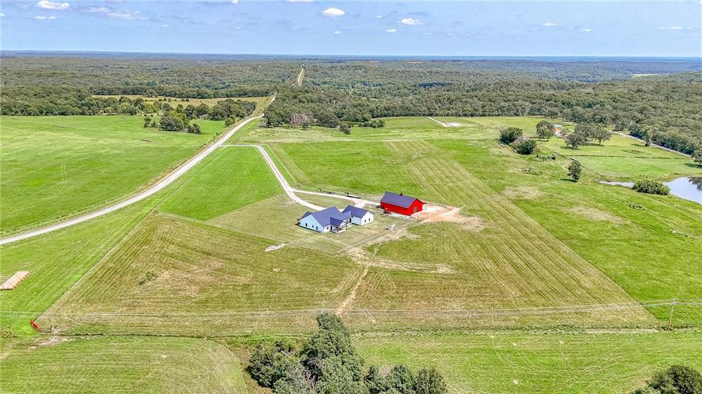 You'll fall in love with this gorgeous home on 17 acres complete with a 40x60 barn and 12ft lean to! Bring all the animals! Custom built and so many upgrades including: black on black double hung windows with tilt sashes, maintenance free exterior doors on front and back, maintenance free soffit, under porch roof metal wood grain siding, open cell spray foam insulation for house and attached garage, 2-reem high efficiency heat pump systems with duel fuel propane backups, Genereac whole house back up generator, Custom kitchen soft close cabinets, quartz countertops, farmhouse sink, amazing walk in pantry for appliance storage and modern slim microwave, GE Cafe 36" commercial gas range, Cafe French door refrigerator and Cafe dishwasher, luxury stone fireplace with electric insert solid core interior doors, high efficiency 50 gal propane water heater, Halo 5 whole house water filtration and conditioner unit, 5x9 custom walk in tiled primary bath shower with 3 shower heads including a rain head, LVP waterproof flooring throughout and upgraded carpet and pad in the bedrooms. insulated custom garage doors on house, garage and barn and new perimeter fencing. Plus more!! You really won't want to miss this home!!