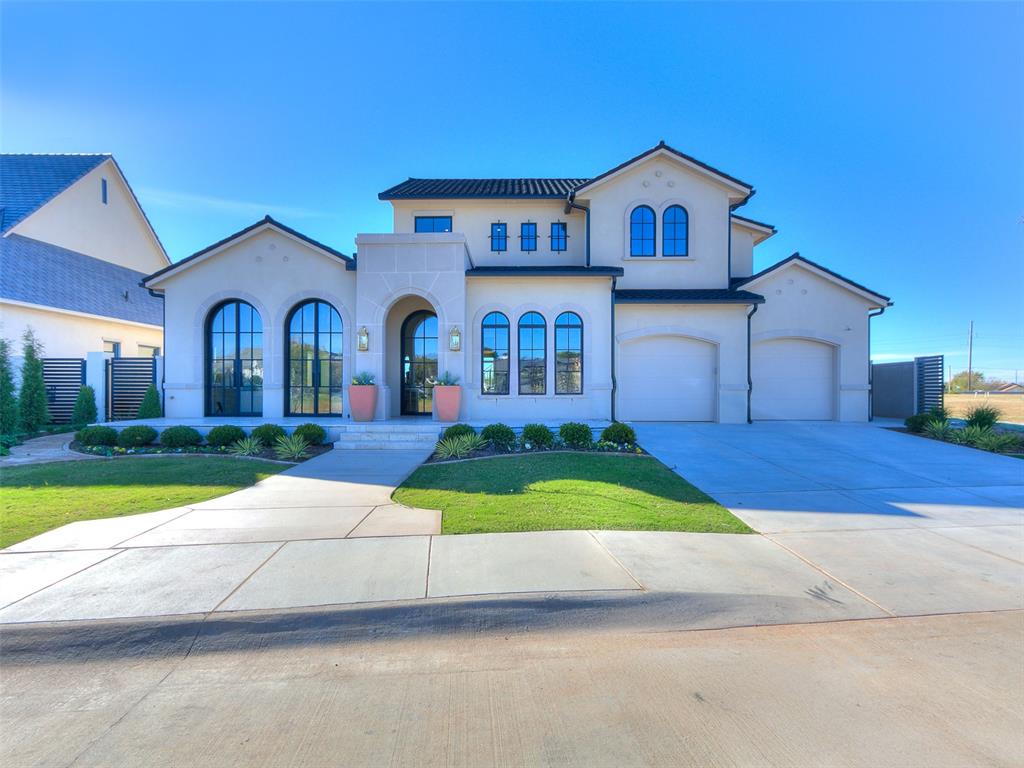 Easy Luxury Living in THE VILLAS at ASHTON GROVE! Welcome to the Villas at Ashton Grove...Norman's premier community offering easy luxury living with picturesque lakes, serene walking paths, and secure entries for your peace of mind. This exquisite home boasts over 3,400 square feet of thoughtfully designed living space, set on a prime .25-acre lake view lot with an oversized garage. Built by Byrd Building, a renowned local luxury home builder who is also a proud resident of the community. From the oversized arched windows to the tile roof, this home epitomizes quality and craftsmanship. The main floor features two beautifully appointed suites, with the primary suite overlooking the breathtaking lake views with a private terrace for ultimate relaxation. And a luxury primary bathroom that sets the mood for calm and tranquility. The expansive great room seamlessly flows into a covered outdoor living area, creating the perfect space for entertaining or unwinding while overlooking the backyard which offers ample room for a custom pool or water feature. The great room is versatile living and dining spaces boasting a beautiful cast stone enhanced fireplace. The study/second living takes in the lake views and is versatile to fit your lifestyle. The chef’s kitchen is a true masterpiece, equipped with top-of-the-line appliances, a huge island, and a generous butler’s pantry. Upstairs, you'll find a media/flex room perfect for movie nights or creative endeavors, plus a spacious bedroom that offers privacy and comfort. An oversized garage offers plenty of space for an automobile lift and/or walk in storm shelter! This home is designed to impress with every detail, providing an unparalleled easy living experience!