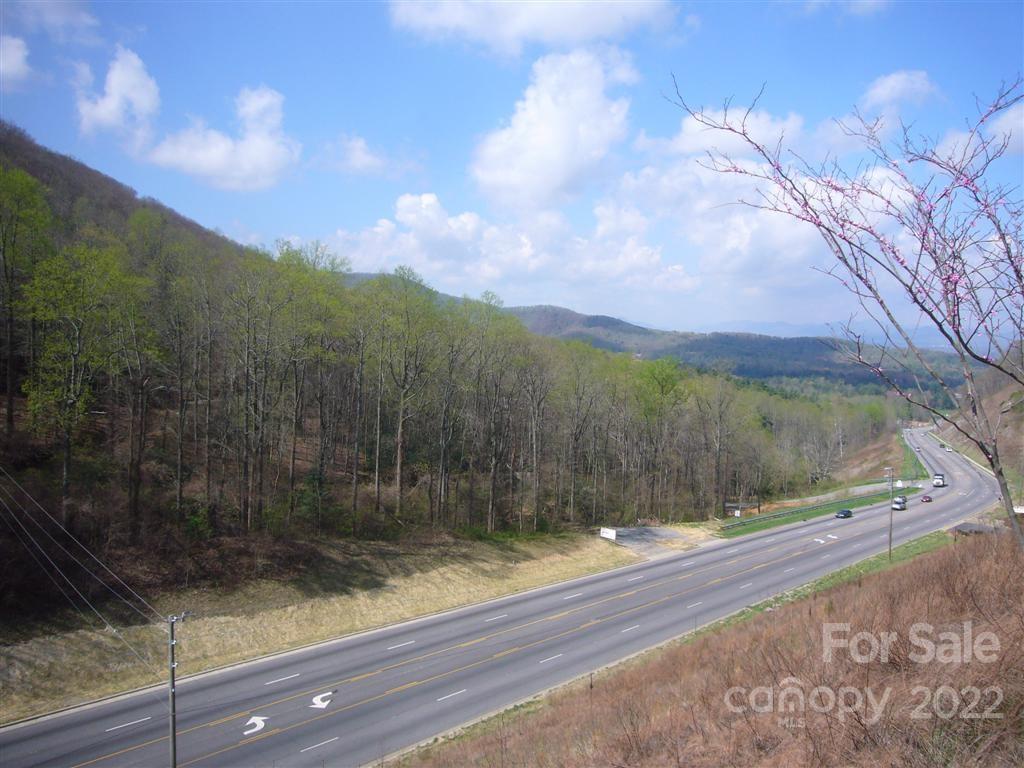 Biltmore Township.  3 miles to I 40, I 240, Blue Ridge Parkway & Asheville Ideal for three to six large multi-family/commercial buildings with lower and upper parking (Needs County approval). Public water, Public sewer (97,500 gallons per day allocation for 250,000 sf of commercial and 800 bedrooms), gas, electric, cable phone on prime corner location at the top of the mountain (Minehole Gap) (over 20,000 cars per day), double access curb cut on 5 lane Hwy 74A, with long range views.  Currently zoned R-LD.  Buyer would need to appeal for commercial or multifamily "conditional use".  Approved for commercial use by Buncombe County Planning Board but not by the commissioners. 6 acres usable with three plateaus, 4 acres steep backdrop for community space.  Total of 1800 feet of road frontage (900' on Hwy 74A, 600' on Cedar Mountain Road and 300' owned on Atherton). Previously under contract for $1,100,000 for assisted living facility. Owner Broker, Cash investor wanted for joint venture.