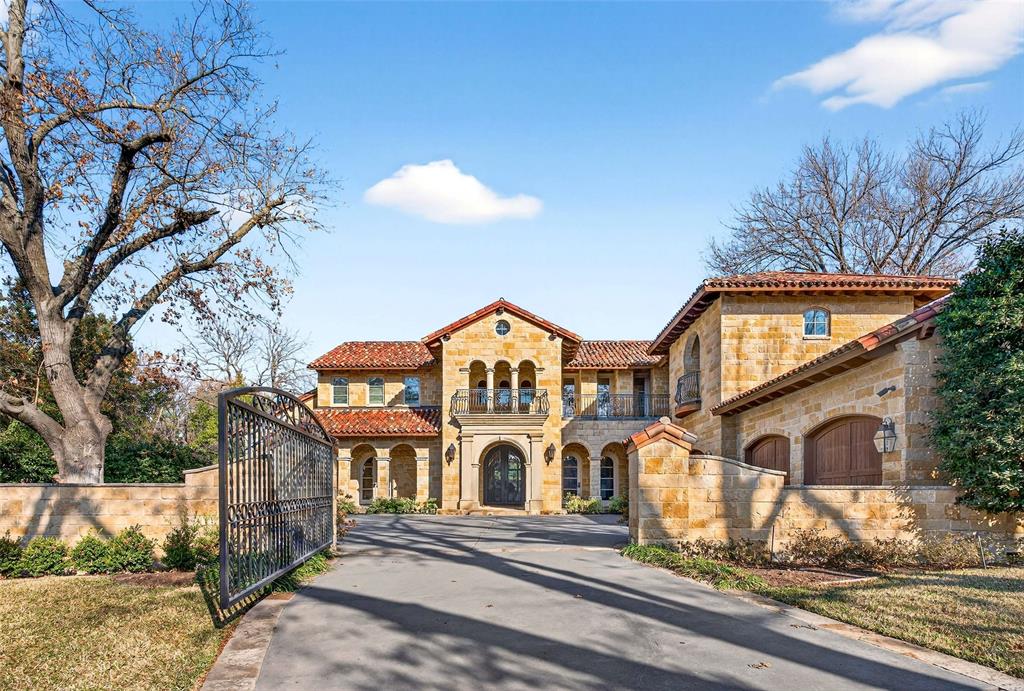 Located on a beautifully landscaped, gated lot of approximately 0.622 acres in coveted Old Preston Hollow, this Mediterranean-style estate offers exceptional scale, privacy, and resort-style living. The expansive 108' x 249' lot features five bedrooms, six full baths, three half baths, and a three individual bay car garage with motor court.The main level is designed for elegant yet functional living, with an open, flowing floor plan that accommodates both formal entertaining and everyday comfort. Spaces include refined formal living areas, a private library or office, a formal dining room and multiple interconnected gathering rooms.The gourmet chef’s kitchen serves as the heart of the home, highlighted by dramatic 21-foot ceilings, commercial-grade appliances, an oversized island, and a full bar with a wine room. It opens seamlessly to the keeping room and family room, creating a natural hub for entertaining and daily living.The first floor includes the primary suite and a guest suite, all with en-suite baths. The primary retreat offers a private sitting room with fireplace, dual spa-like bathrooms, and two expansive walk-in closets. Upstairs, three additional en-suite bedrooms are joined by a large game room with private balcony and a dedicated fitness room.Outdoor living is a standout feature, with approximately 2,000 square feet of covered spaces, multiple terraces, and two covered patios. The resort-style backyard includes a pool with tanning ledge, spa, fountain, and multiple water features. Heat lamps extend year-round usability in the covered patio, while 12-foot holly hedges provide complete privacy with no sightlines from neighboring properties. This is a rare opportunity to own a private estate in one of Dallas’ most prestigious neighborhoods.