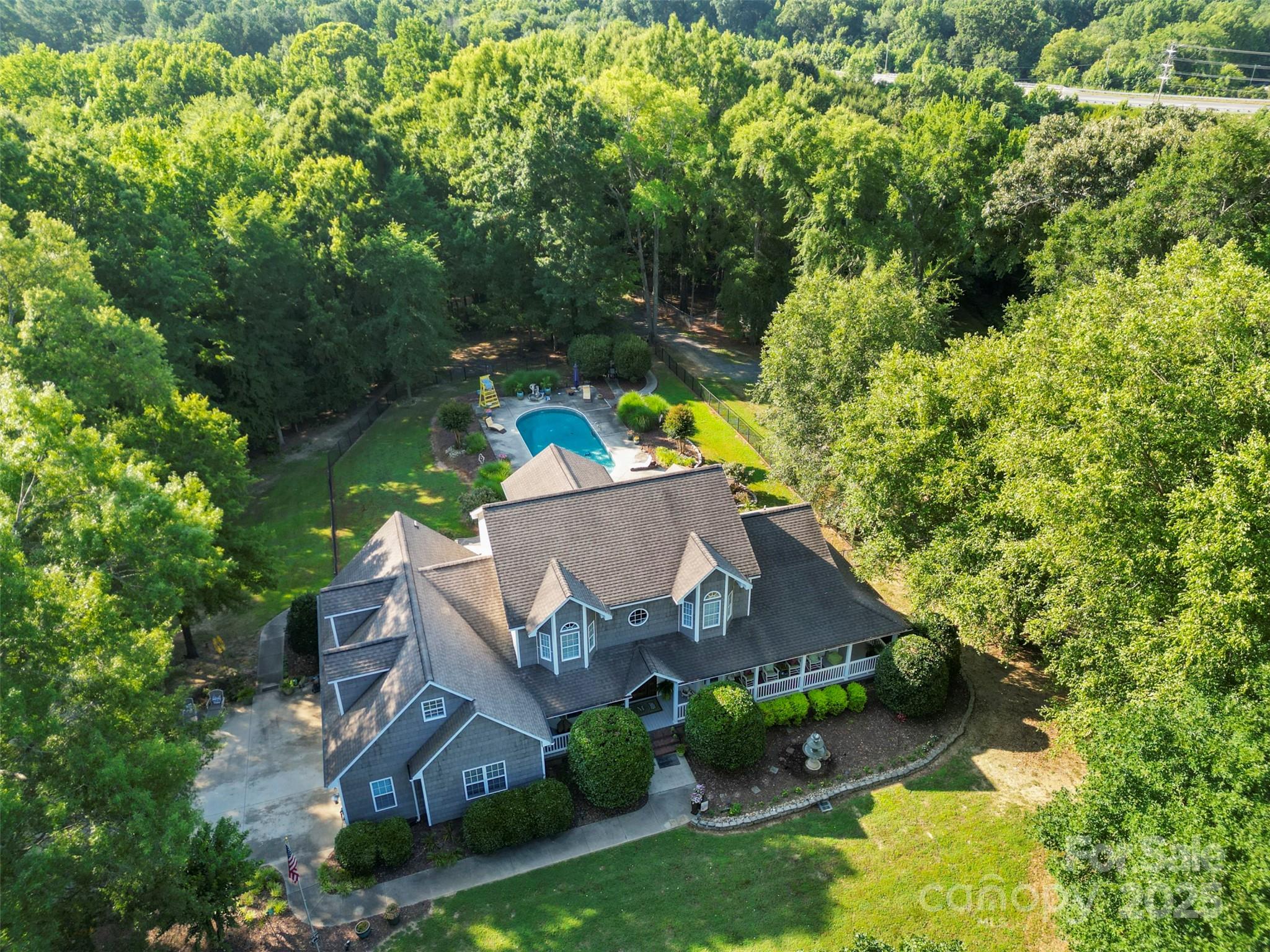 Welcome to your private retreat nestled on nearly 15 acres with a creek running along the back of the property. The main floor features a primary suite with a large walk-in closet, a private bath, and a separate sitting room. You’ll also find a cozy living room with a fireplace, kitchen, formal dining area, breakfast nook, and laundry room. Upstairs has two spacious bedroom suites—each with private bathrooms and sitting areas—plus an office space and an additional finished room with its own HVAC unit, offering flexibility for a hobby room, playroom, or media space.Step outside to the in-ground pool and expansive outdoor patio area—ideal for entertaining. A detached double garage and a second residence sits just behind the pool. This charming 629 sq. ft. guest house includes 1 bedroom, 1 bathroom, a living area, kitchen, laundry hookups, front and back porch!

Additional features include a city easement near the creek at the back of the property.