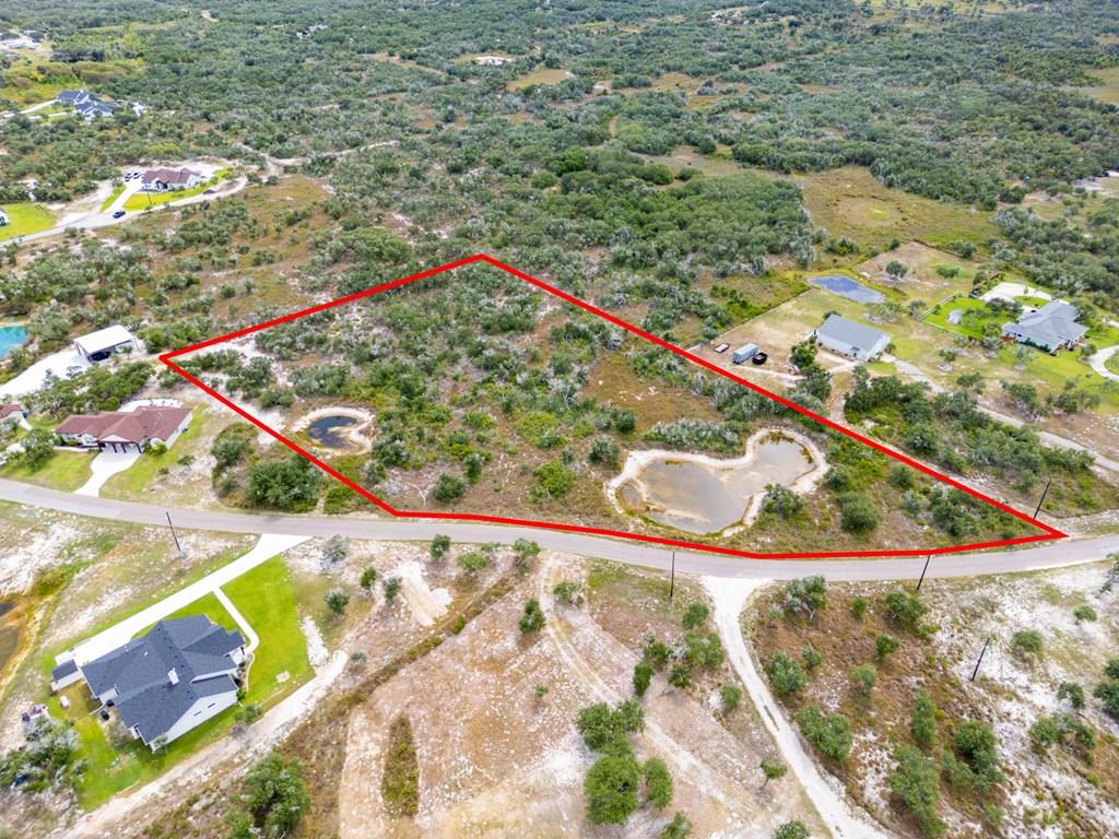 New Price!!! $220,000 Cleared and ready for your plans. Almost 3.5 acres. Discover the perfect balance of seclusion and convenience in this estate-style neighborhood between Rockport and Aransas Pass. This spacious lot is adorned with majestic oak trees, abundant wildlife, and two picturesque ponds. While just a quick drive to the Bypass for easy commuting, the setting feels private and serene—yet you're still only minutes from downtown Rockport and the Cove Harbor Boat Ramp. Create your own private oasis in this desirable community—all at an exceptional value. Don't miss the opportunity to see this gem today, buildable lots are running out. Bring your Plans and your vision and make this yours.