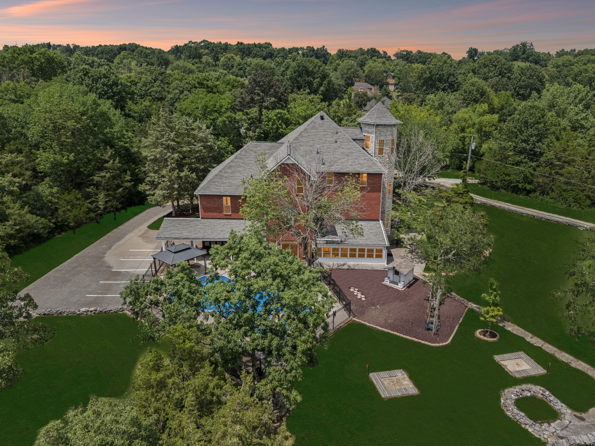 LOCATION With INCOME POTENTIAL!!! WILSON COUNTY RARE FIND! $20,000 Offered Toward Closing Costs & Title Expenses! This AMAZING HOME is like being on vacation every day, and "oh the memories you will make here!" This 4 level 7,385 Sq Ft, home is nestled on 1.8 private acres & has something for everyone, and somewhere for everything! 8 of the rooms are set up as Bedrooms (Septic is 3), 7+ Baths, a Theatre Room, a Sunroom, Game Room (Could be Formal Dining), a Workout Room, Eat-in Cooks Dream Kitchen, & a Special 4th Floor Hideaway Space that includes a Sunlit, Private Turret & a 1/2 Bath. Outside is an UNRIVALED ADULT & CHILDREN'S PLAYGROUND! FOR RELAXING & ENTERTAINING there are Covered Front Porches on 3 levels, a Sparkling Salt Water Pool w/ a Turbo Twister Water Slide, Oversized Covered Back Patio with ceiling fans, a huge Fire Pit Area w/ a large supply of seasoned firewood, Horseshoe Pit, A Pickleball & Basketball Court, Children's Play Area including a Playhouse, Swingset, & Hopscotch all in a bed of "soft landing" rubber mulch. In addition to the Main House there is a 960 Sq Ft Detached Full Apartment. The Apartment has endless possibilities and could be used to generate rental income, serve as residence for a Caregiver, House or Grounds Staff, etc. PLUS  a 30'x60' Heated & Air Conditioned Workshop w/ Full Electric, Water & its own 1/2 Bath that would make a great workspace for a home business. There are 4 HVAC units for the main house & there's even a connection/transfer switch set up for a generator. The Sellers thought of Literally EVERYTHING one could want in this ONE-OF-A-Kind home. Enjoy it as your own private retreat, or invite family & friends to partake in all this wonderful property has to offer. All Movie Theatre Seats, Washer & Dryer in Main House & Apartment, All Refrigerators, Playhouse, Swingset, & Log Pile Remain.