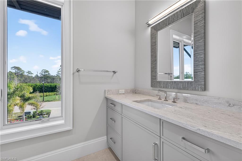 Bathroom featuring vanity and baseboards
