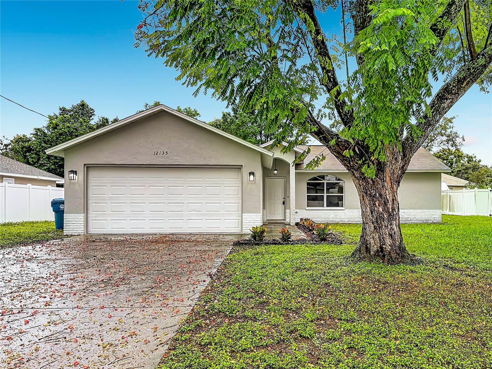 Exceptional value in highly sought after Spring Hill! This beautifully remodeled 3-bedroom, 2-bath, 2 car garage, 1,244 sq ft single family home offers a fresh, modern feel with new interior and exterior paint, Completely remodeled kitchen with brand new cabinetry, quartz countertops, stainless steel appliances, updated lighting, and laminate wood flooring throughout. Both bathrooms have been fully updated with new fixtures, finishes, and lighting. The spacious primary suite offers an en-suite bathroom featuring a stand-up shower and a walk-in closet. A spacious screened in lanai which is the perfect spot to relax or entertain. Move-in ready, beautifully updated, and packed with desirable upgrades, this is one you won’t want to miss!