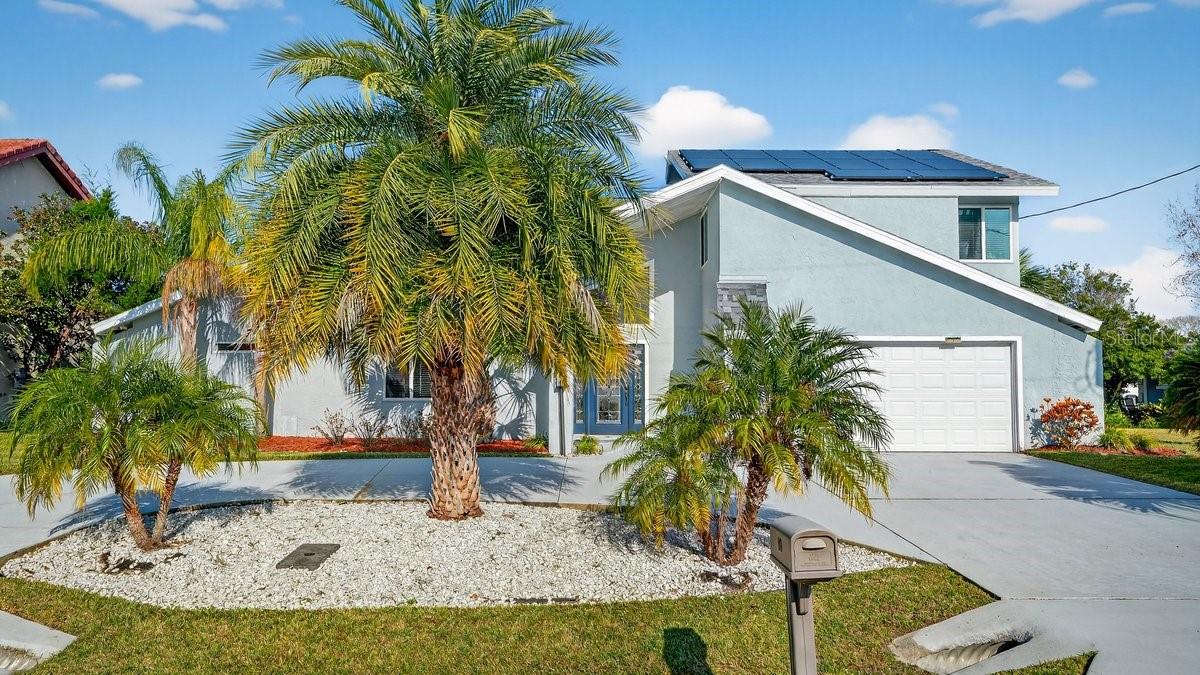 Discover this stunning vintage contemporary waterfront gem—a fully furnished 4-bedroom, 3-full-bath pool home ideal for year-round living, seasonal getaways, or continued success as a lucrative vacation rental. Step from your backyard's serene saltwater canal to the Intracoastal Waterway in just a short boat ride.What sets this home apart is its striking geometric architecture, paired with extensive modern upgrades from 2019 to the present, ensuring unparalleled comfort and functionality. Indoor-outdoor living takes center stage, highlighted by a massive salt-system pool (resurfaced in 2021) surrounded by expansive open decks for relaxation. Elevate your waterfront lifestyle with a covered 26-foot boat dock and a dedicated double jet-ski lift (installed in 2022). A cutting-edge solar panel system keeps average electric bills remarkably low.Enter to breathtaking pool and water views through an open-concept layout, accentuated by soaring vaulted ceilings, a craftsman staircase, and an upstairs loft overlooking the space below. The heart of the main level is a sleek double-sided electric fireplace (installed in 2025) seamlessly dividing the family and dining areas.The split-bedroom floor plan offers privacy and convenience: the luxurious owner's suite and one secondary bedroom on the main level, plus two upstairs bedrooms sharing a well-appointed bath. The chef-inspired kitchen (renovated in 2021) boasts exotic granite countertops, premium stainless steel appliances, and a central island with an exhaust hood—perfect for entertaining while soaking in the scenic vistas.A spacious circular concrete driveway (installed in 2021) provides ample parking for guests. Nestled in the vibrant heart of Palm Coast, you're minutes from shopping, dining, and pristine beaches. Don't miss this extraordinary property—schedule your private showing today!