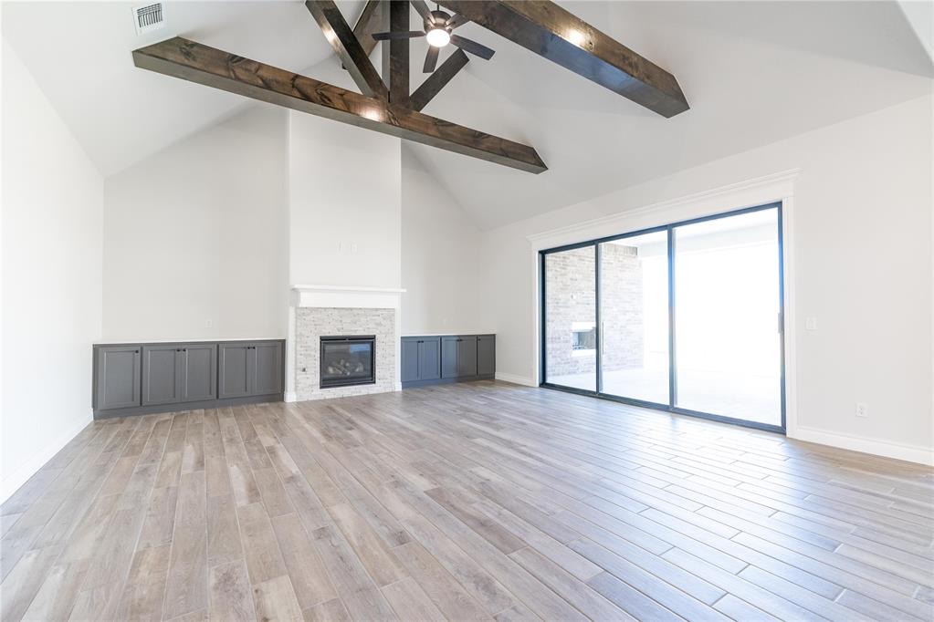 This Wesley Bonus Room floor plan includes 3,630 Sqft of total living space, which features 3,285 Sqft of indoor living space and 345 Sqft of outdoor living space. There is also a 590 Sqft, three-car garage with an in-ground storm shelter installed! This desirable home offers 5 bedrooms, 3 full bathrooms, covered patios, a large bonus room, a powder room, and a utility room featuring a utility sink. The great room supports an immaculate cathedral ceiling with a crows feet detail and a ceiling fan, a luxurious 3-panel sliding door with a 4’ back patio extension, wood-look tile, rocker switches throughout, Cat6 wiring, eggshell paint, and a gas fireplace featuring a stacked stone detail and built-in lower cabinets on both sides. The upscale kitchen boasts stunning pendant lighting, stainless steel appliances including double ovens and a 5-burner cooktop, 3 CM countertops, vogue tile backsplash, well-crafted cabinets to the ceiling with cabinet hardware throughout and under cabinet lighting, decorative end panels, a separate walk-in pantry, and a large center island that holds a roomy sink, a dishwasher, and a trash can pullout. The primary suite provides a sloped ceiling detail, a ceiling fan, a plush carpet finish, and windows. Attached is the main bath, which has a bat-winged vanity with framed mirrors, 3 CM countertops, a large European walk-in shower, a private water closet with an elongated toilet, a free-standing tub, and a HUGE walk-in closet! The covered outdoor living area welcomes a wood-burning fireplace, a gas line for your grill, and a handy TV hookup. Other included features for this elegant home include our healthy home technology, an air filtration system, a tankless water heater, double glazed vinyl low E windows with argon, R-44 and R-15 insulation, a fresh air ventilation system, and so much more!