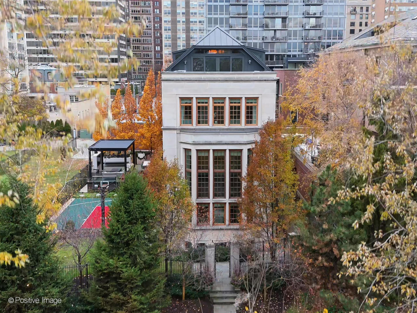Rare opportunity to own an impeccably maintained single-family residence on Lake Shore Drive, situated on an expansive 64' x 200' lot with approximately 9,000 square feet under roof. This exceptional home offers 7 bedrooms and 7.5 baths and features multiple outdoor living spaces, including a Sport Court, a 30' x 25' terrace, and a 30' x 20' garage rooftop terrace with a custom outdoor kitchen-ideal for entertaining. A dramatic foyer welcomes you into the main level, which features a gourmet kitchen, great room, and a striking living area with soaring 20+ foot ceilings, a gas fireplace, and a dining space overlooking Lake Shore Drive. The kitchen is appointed with custom white cabinetry, natural stone countertops, professional-grade appliances, a dedicated coffee and beverage nook, and a built-in breakfast banquette. The seamless indoor-outdoor layout opens to a pergola-covered entertainment terrace with lounge seating and a fire pit, offering direct access to the backyard and an integrated sports court. A striking custom double staircase connects the upper levels. The second-floor features three light-filled ensuite bedrooms with custom-builtin storage. The third floor is home to a refined primary suite with custom millwork, a fireplace, and a tucked-away sitting area. The spa-inspired primary bath features an oversized rain and steam shower, a soaking tub, dual vanities with Calacatta marble countertops, and heated marble floors. A spacious dressing room features a center island. An additional ensuite bedroom and a laundry room complete this level. The top floor showcases  exceptional custom woodwork and offers a large bar and entertainment lounge, a half bath, a workout room, and two rooftop decks with open  views. The lower level includes a family/media room, wet bar, full bath, an ensuite bedroom, ample storage, oversized refrigerator and freezer  capacity, and a mudroom with direct access to the 3-car garage. Additional highlights include a Control4 audio system, an elevator, individual HVAC zones, a security system, an irrigation system, and outdoor snow-melt. In addition to the 3-car garage, the property offers two outdoor parking spaces with gated, secure alley access