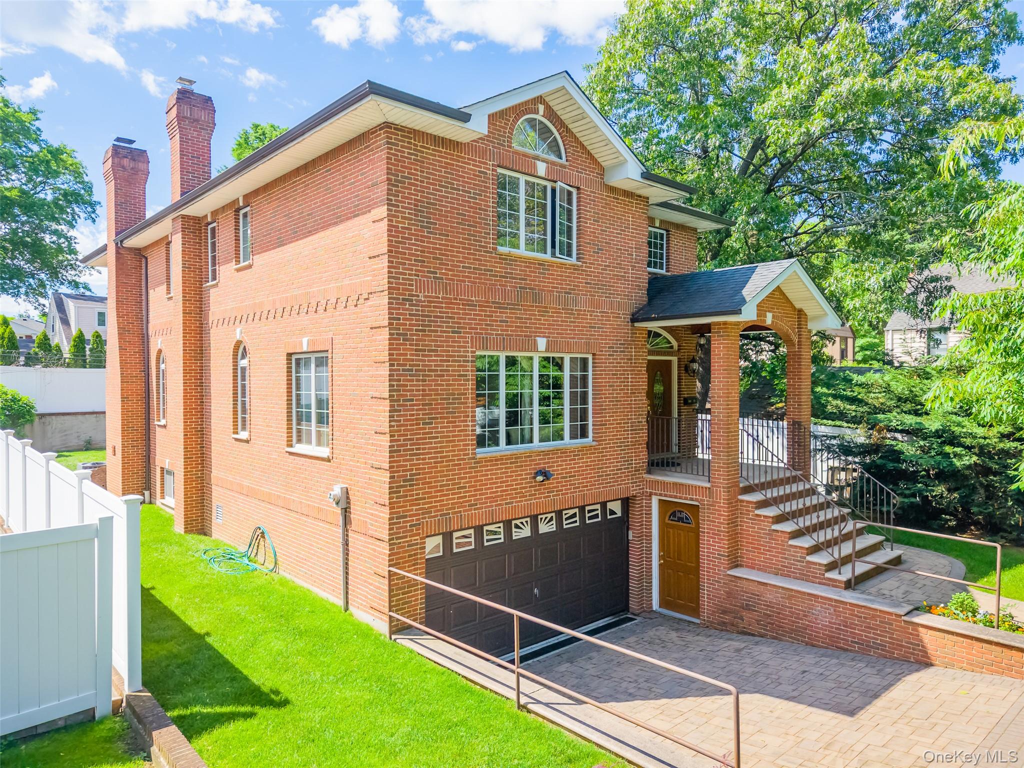 Rare custom-built brick Colonial in a prime Queens location. Built in 2015, this well-maintained home offers approximately 2,800 SF of living space on a 5,200 SF lot, featuring central A/C, high ceilings, hardwood floors, radiant heated floors, and bright north-south exposure.The first floor includes a living room, dining area, family room, gourmet kitchen with cherry cabinetry, and 1 full bath. The second floor offers 3 bedrooms and 2 full baths, including a primary suite with Jacuzzi tub and separate shower.The walk-in finished basement has a separate entrance, 2 rooms, and 1 full bath. Additional highlights include a new boiler system, 2-car garage, landscaped garden, and approved property tax reduction, with 2027 taxes expected around $13,000.Conveniently located near District 26 schools, shops, New World Supermarket, restaurants, LIRR, and Q12/N20G buses to Flushing. Approx. 25 minutes to Manhattan by train.A rare opportunity offering custom quality, flexible use, rental potential, and excellent transportation convenience.