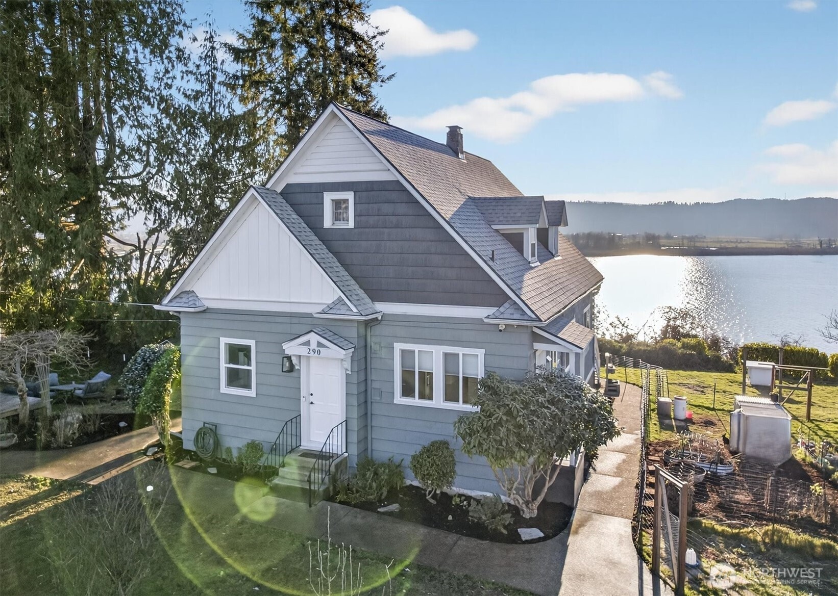 Step back in time and fall in love with this enchanting, updated 1890 home perched on one of Cathlamet’s most generous city lots—offering rare elbow room and jaw-dropping panoramic views of the mighty Columbia River. The home shines with thoughtful modern updates that honor its historic soul: fresh paint, updated systems, and tasteful fixtures throughout. The newly updated kitchen is open concept with living space, while the separate living room leads to the sunroom, which would make a great studio or office with fantastic water views. Upstairs a luxurious primary suite retreat—complete with its own full second kitchen and a sauna—great for multi-generational living, guests, rental potential, or simply enjoying peaceful separation and river vistas from your bedroom windows. Outside, the extra-large, fully fenced yard is a true highlight: plenty of space for gardens, play, pets, outdoor dining. A detached 20x20' garage/shop provides excellent storage, workspace, or a hobby haven. Just a short stroll from charming downtown Cathlamet—known for its friendly locals, riverfront access, public marina, restaurants, art galleries, and community events. This is small-town Pacific Northwest living at its finest: quiet, scenic, and welcoming, yet only a scenic drive from larger amenities. A truly rare find in Wahkiakum County—historic beauty, modern comfort, generous space, and unbeatable river views. Properties like this don’t come around often!