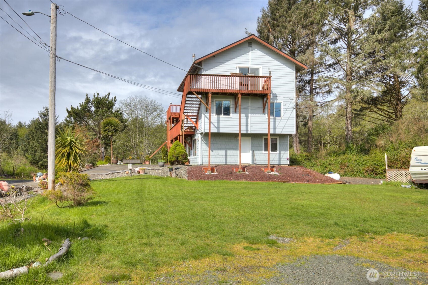 This custom built 4 bedroom, 3 bath home offers exceptional flexibility with a large downstairs apartment featuring its own private entry- ideal for multi-generational living, guest accommodations, or nightly long-term rental income. The layout is thoughtfully designed, providing comfort, privacy and a wide range of possibilities. Main floor includes 2 bedroom, full bath, spacious living room and well appointed kitchen creating a complete living space with easy access. Upstairs, the primary suite feels like a retreat offering walk-in closet, double vanity, soaker tub & shower. A light filled catwalk leads to a large private deck overlooking Conner Creek, where river otters, blue heron and turtles reside. Located at the end of a private road this home offers peace and privacy while just 300 ft. from drive on beach access road. New roof 2019. New siding 2014. Septic pumped & inspected 5/2022. RV parking.