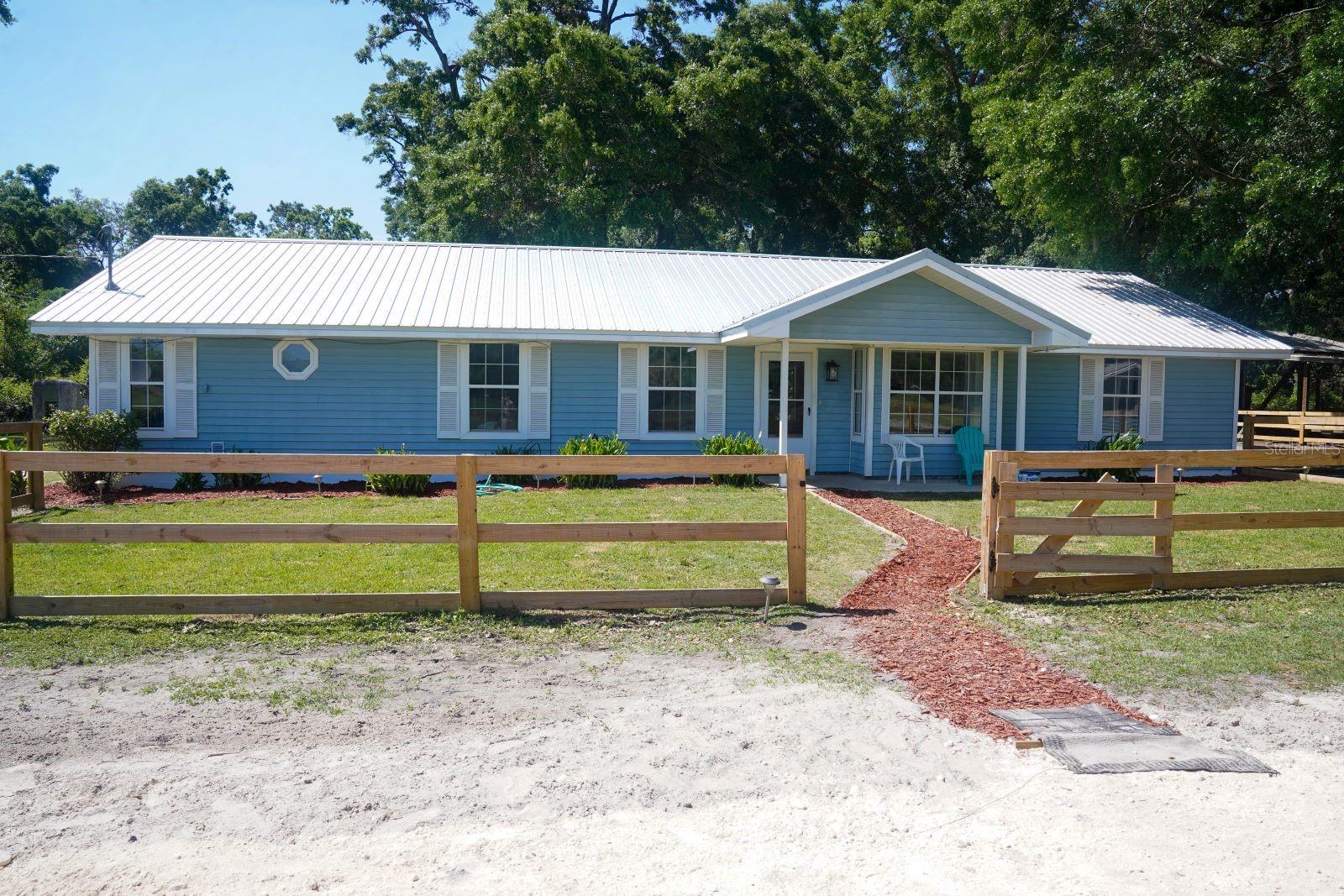 Welcome Home! This stunning 12.62 acre property offers the perfect blend of farm life, and country living mixed with a hint of luxury.  This beautiful, peaceful Farm located in the quietness of country living awaits you.  The owners have maintained this charming three bedroom, two bath home, with many updated features.  The bath in the master suite includes a walk-in shower, with a claw foot tub evoking a sense of nostalgia of a bygone era when bathing and provides an indulgent and luxurious experience. The claw foot tub adds a touch of Victorian-era charm to the spacious bathroom.  The heart of the home features updated kitchen appliances and a kitchen island that offers an abundance of counter space.  This spacious layout has many upgraded finishes throughout the recently interior painting of the home such as 39 new electrical outlets, new hot water heater, glass top electrical stove (1 yr), stainless steel refrigerator w/freezer on bottom (1 yr) and tile flooring throughout. Did I mention – it has a new roof and comes with a washer and dryer.  Also, the Owners recently added a new Security System - which includes a Motion Sensor, a wireless Sensor Bundle, 13 Window Sensors, a Smoke and Carbon Monoxide Detector, 3 Smoke Detectors, a Keychain Remote, Google Nest Video Camera Doorbell, 24/7 infusion monitoring, and multiple yard signs and stickers.  Don’t wait to make this dream home your reality. Take a step into life away from the hustle and bustle of city life. This farm is not just a home, it’s a lifestyle ready for you to make this Farm your very own.   It has a covered, screened back porch which features ample space for sitting outside and enjoying a cup of coffee in the morning or sitting outside for dinner in the evening.  This stunning Farm offers the perfect blend of comfort, space, and functionality.  It is ideal for those seeking a rural retreat with room for livestock, outdoor adventures, and endless comfort and relaxation.  The possibilities are endless.  It has the availability of fiber optic connectivity ensuring ultra-fast and reliable internet access through Central Florida Electric Cooperative.  This property is designed to accommodate a variety of livestock and animals, making it a haven for farmers, animal lovers and enthusiasts.  It currently has  20  guinea bird, 14 beautiful peacocks,  donkeys, ducks and many other animals.  Don’t miss this extraordinary opportunity to own a beautiful farm that embraces the harmony of rural life, animal care, and many other enchanting natural features.  Get ready to enjoy the serenity of country living with just a short drive to shopping and dining.  This location provides an easy drive to Newberry, Gainesville, Lake City and Chiefland.  Call today to schedule your tour - you will be impressed.