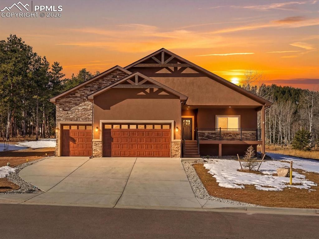 Tucked into the desirable Stone Ridge Village community of Woodland Park, this beautifully crafted ranch-style residence offers the perfect balance of modern comfort and effortless main-level living. With over 2,173 square feet, 4 bedrooms, 2 baths, and an oversized 3-car garage, this home was thoughtfully designed for both everyday ease and elevated entertaining. A welcoming foyer opens into a light-filled great room anchored by soaring vaulted ceilings and a dramatic floor-to-ceiling stone gas fireplace, creating a warm yet sophisticated gathering space. The open-concept layout flows seamlessly into the chef’s kitchen, where premium granite countertops, custom soft-close cabinetry, a spacious island with built-in cooktop and downdraft, and a large walk-in pantry combine style with function. Walk out to the covered concrete patio - complete with gas hookup for seamless indoor-outdoor living and year-round enjoyment. The primary suite offers a peaceful retreat with private patio access, a spa-inspired bath featuring dual vanities and a walk-in shower, and a custom wardrobe closet designed for optimal organization. Three additional bedrooms provide flexibility for guests, office space, or hobbies. No detail was overlooked in the construction of this home. Engineered hardwood flooring, solid-core doors, upgraded insulation, energy-efficient Mezzo windows, a tankless water heater, and a radon mitigation system provide quality and peace of mind. The heated crawl space offers exceptional additional storage. The oversized three-car garage is equally impressive, featuring epoxy-coated floors, and a hot/cold water spigot - ideal for Colorado living in every season. Set on a landscaped lot just minutes from Woodland Park’s charming downtown, local schools, and scenic trails - and an easy commute to Colorado Springs - this home presents a rare opportunity to enjoy refined mountain living in one of Teller County’s most sought-after neighborhoods.For more info, visit: https://dominicmillerhomes.com/stone-ridge-village