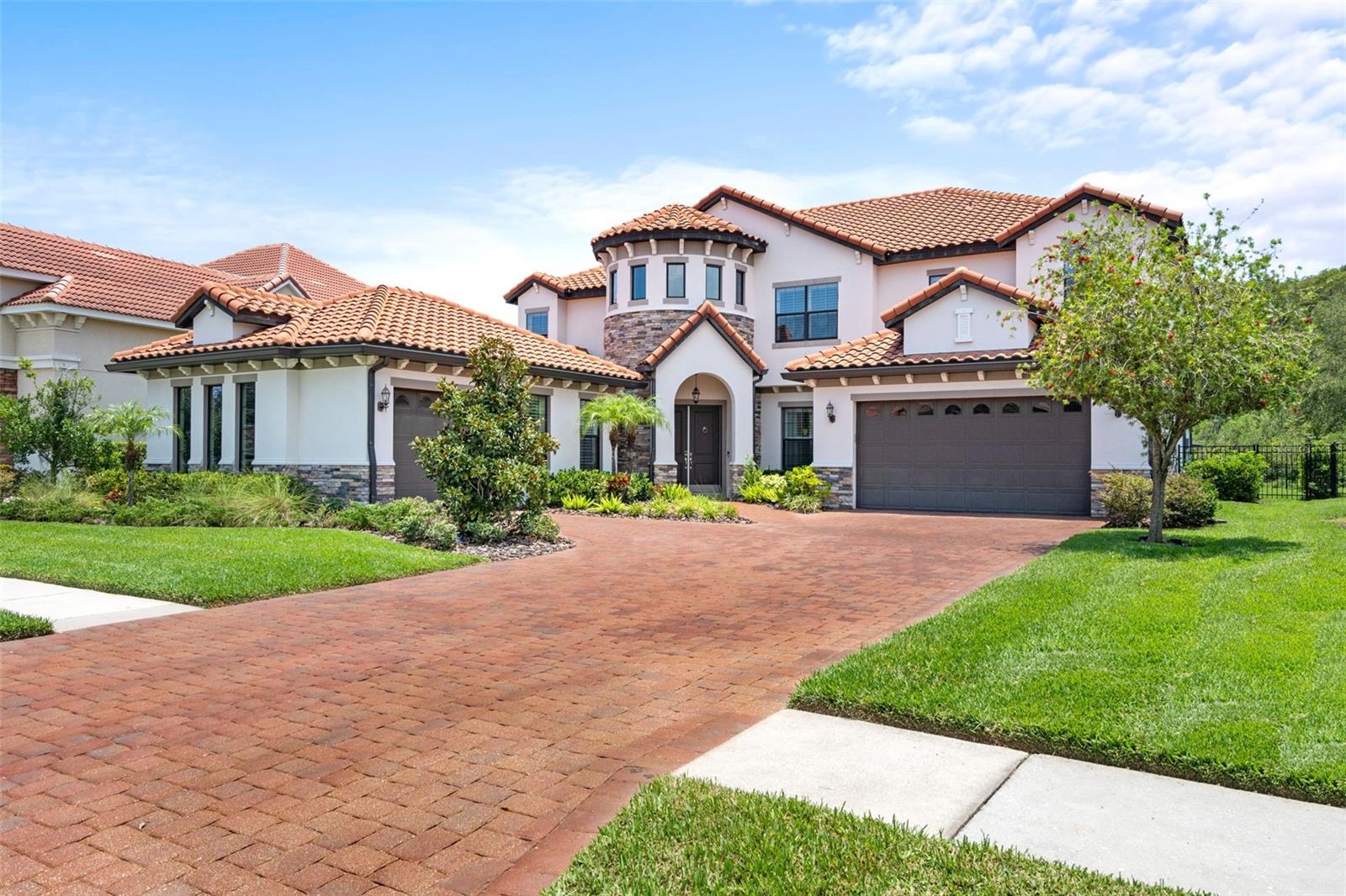 PRIME LOCATION! Welcome to a FUN RARE LUXURY POOL HOME nestled in a 24/7 GUARD-GATED Prestige Community of Grand Hampton. From the moment you arrive, this RECENTLY UPDATED Custom Residence exudes Elegance & Comfort on a SPRAWLING LOT with Privacy & BREATHTAKING VIEWS of the Surrounding Conservation Area with No Rear Neighbors. ONLY 2-OWNERS initially Occupied by NFL Tampa Bay Bucs Super Bowl Champ! Offering Luxury & Sporting History. The MANICURED LANDSCAPING and long driveway leads you to SPACIOUS GARAGES and a STRIKING ARCHITECTURAL Design. As you step inside this 6 BEDROOM + FULL OFFICE, 5 FULL-BATH and 2 HALF-BATH's, you're greeted by an incredible Light Filled OPEN FLOOR PLAN. The home combines traditional charm with LUXURIOUS MODERN FINISHES. A Grand TWO-STORY foyer sets the stage, adorned with a Feature Staircase, Sparkling Crystal Chandeliers, Designer Flooring, Crown Molding, Tankless Water Heater, Built-in Home Scenting System and whole-home WATER FILTRATION SYSTEM. The Living & Dining spaces are beautifully appointed, perfect for hosting gatherings of any size. The GOURMET CHEF's KITCHEN is a highlight, featuring RICH CUSTOM SOFT-CLOSE CABINETRY with ample STORAGE SPACE and ROLL-OUT CABINETS, Luxurious CAMBRIA Quartz Countertops, and High-End Stainless Steel Appliances. A BONUS BREAKFAST BAR adds casual seating for Family & Friends. Entertainment seamlessly flows into the BACKYARD PARADISE, a Dream for Outdoor Living. OVERSIZED GLASS DOORS with Custom interior MOTORIZED DRAPES lead to an EXPANSIVE PATIO features state-of-the-art remote controlled ENCLOSED SCREENS with TRAVERTINE Stone Flooring. An OUTDOOR KITCHEN: offers a built-in Gas BBQ GRILL, Sink, Fridge, SunBrite-TV, invites culinary adventures. An adjacent OUTDOOR PRIVATE BATHROOM, and in-pool PATIO BUILT IN FIREPIT. A 7ft Deep SALTWATER POOL with Water Fountains & INFINITY SPA along with Multi-Color LED lights complete the RESORT-LIKE EXPERIENCE. Inside, every detail has been Meticulously Designed. OVERSIZED STUNNING MASTER SUITE is located on the Main Level along with EN-SUITE BEDROOM. The Master boasts separate DUAL WALK-IN CLOSETS and PRIVATE PATIO ACCESS. Two separate vanities, Oversized WALK-IN SHOWER, and a SOAKER TUB. Featuring a LARGE UPSTAIRS with a OUTDOOR COVERED BALCONY for relaxation, a Den with IN-CEILING SURROUND SOUND for Entertainment that includes 3 T'Vs, and a WET BAR with Built-In Temp Controlled WINE COOLER. A custom MOVIE THEATER ROOM designed with velvet insulated noise cancelation, plush carpeting, 13 Reclining-Seats equipped with a State-Of-The-Art SONY Projector. The theater delivers HD Visuals that bring Movies to Life, complementing with a PREMIUM SOUND SYSTEM that promises a Cinematic Experience. Grand Hampton offers RESORT-STYLE AMENITIES: heated pool, spa, lap pool, fitness center, tennis/basketball courts, playground, lake w/dock & pier, and walking trails. EASY ACCESS to I-75/275, a SHORT RIDE to DOWNTOWN and AIRPORT. Surrounded by Several GOLF Courses, Athletic Clubs, Private Schools, Colleges & Hospitals. For SHOPPING & DINING Enthusiasts, you're just minutes away from the Wiregrass Mall, Premium Outlet Mall, a Variety of Restaurants along with many ENTERTAINMENT ATTRACTIONS! Whether you're looking for family-friendly activities or leisure pursuits, there's something for everyone. HOME is NOT IN FLOODZONE. Power was NOT LOST during storms! (under "FACTS & FEATURES" Click on "SHOW MORE" scroll down to VIRTUAL TOUR & WATCH THE VIDEO)