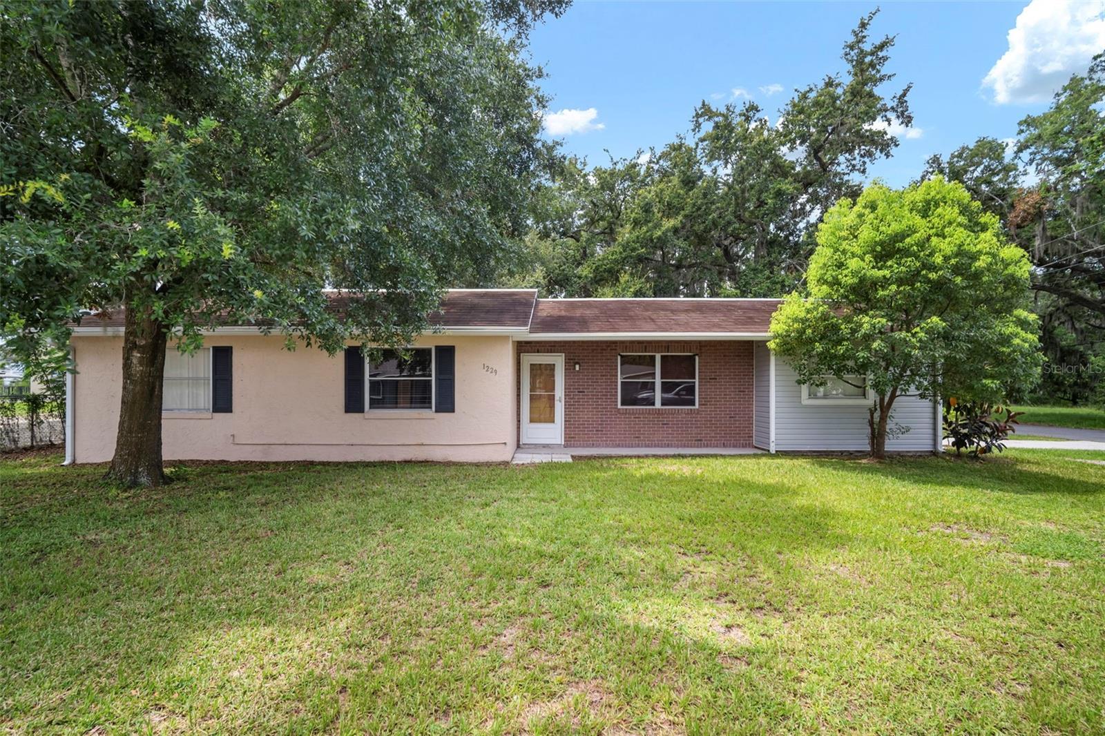 Charming ranch-style home ideal as a starter residence or investment opportunity. This spacious 4-bed, 2-bath floor plan features a bright galley kitchen with newer appliances and a dining area designed for storage and family meals. A generous great room welcomes you at entry while a separate family room offers flexible space for an office or additional bedroom.

The laundry room comes equipped with extra cabinetry, and updates include a newer AC, water heater, and modern flooring throughout the living spaces. The fully fenced yard and corner location provide privacy and curb appeal. No HOA or deed restrictions - bring your boat or RV! Minutes from the Strawberry Festival Grounds. See it today!